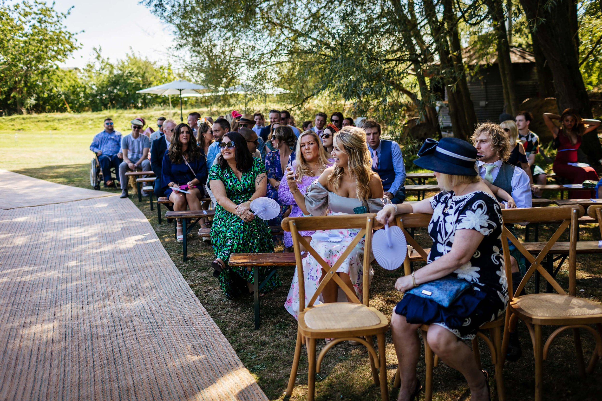 Wedding guests await the arrival of the bride for the ceremony