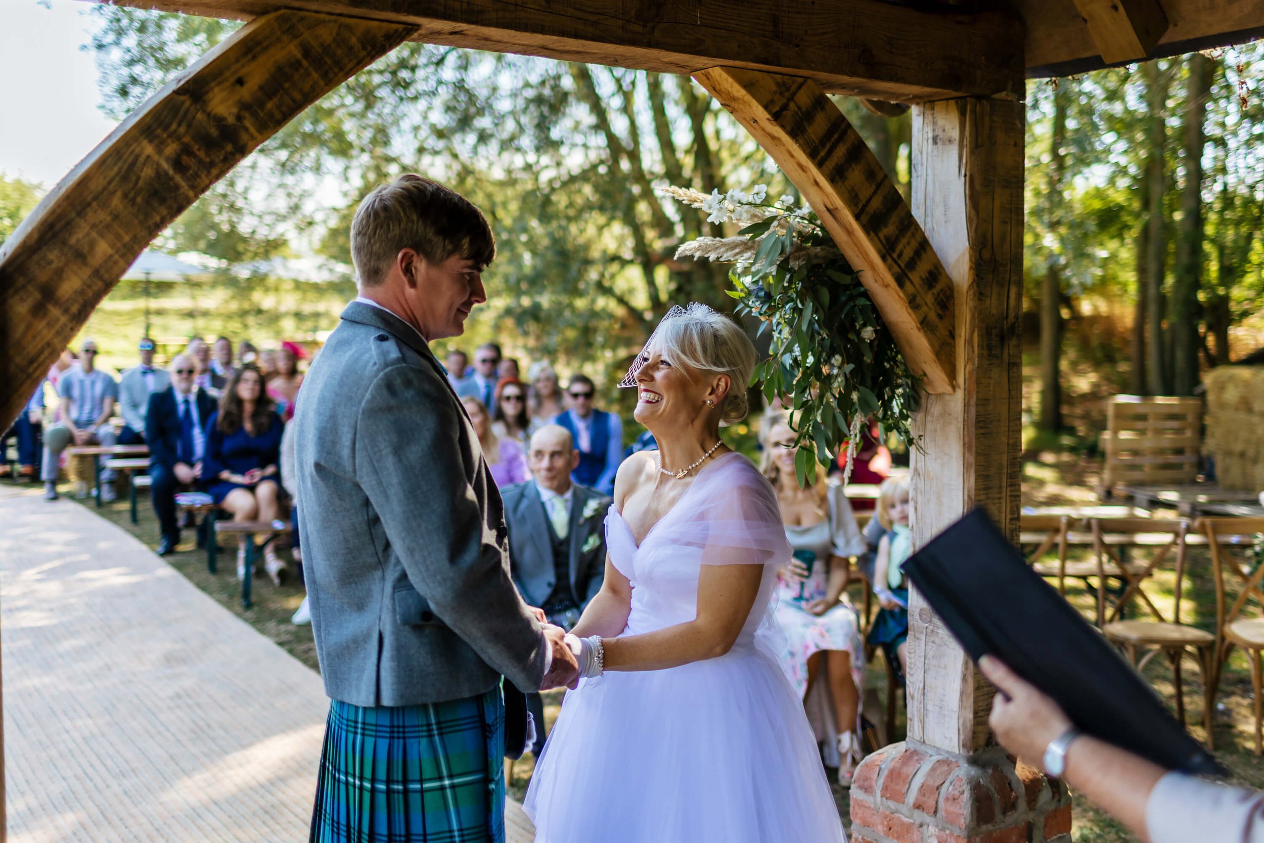 Bride and groom laughing during their wedding ceremony