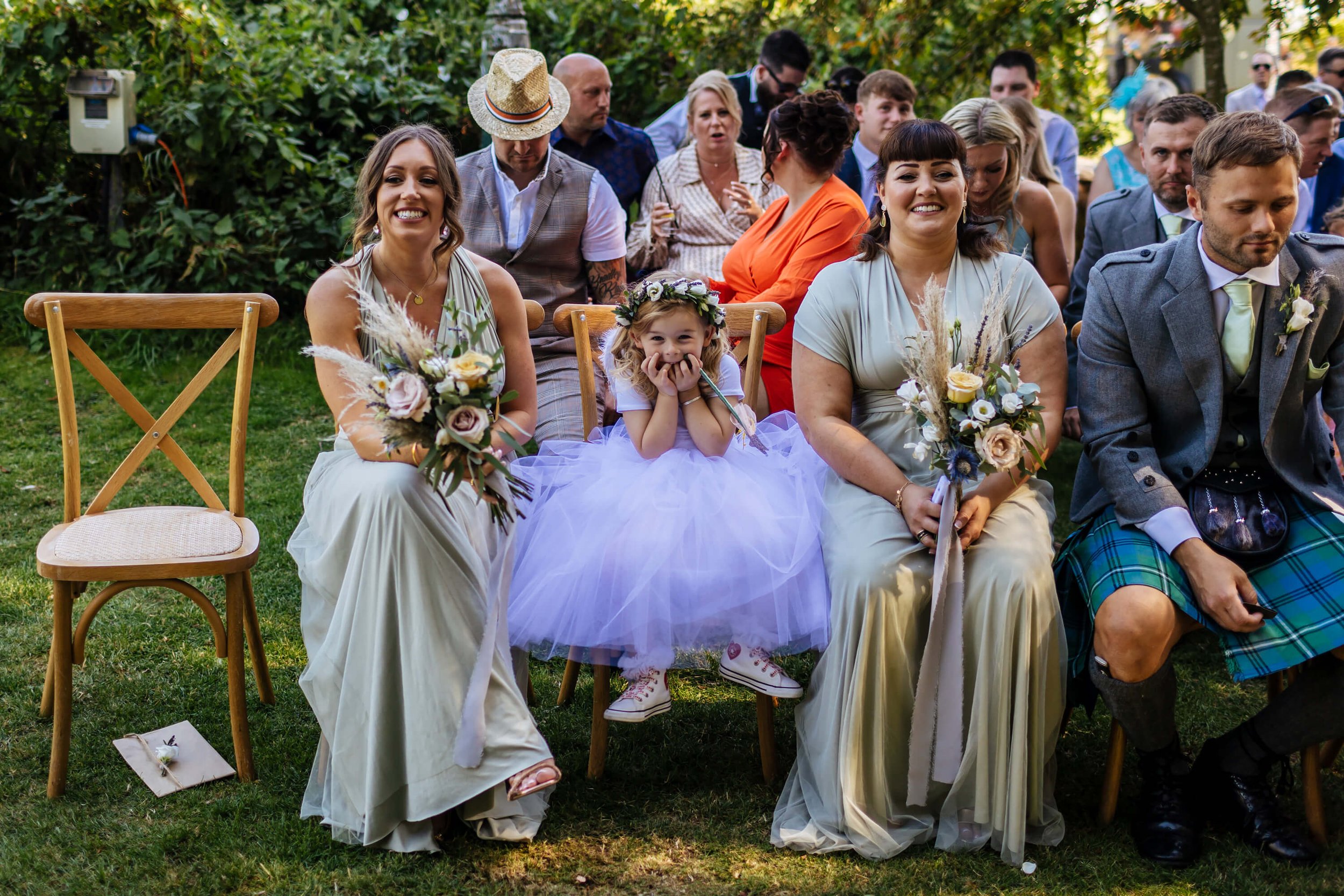 Bridesmaids and flower girl smiling during the wedding ceremony