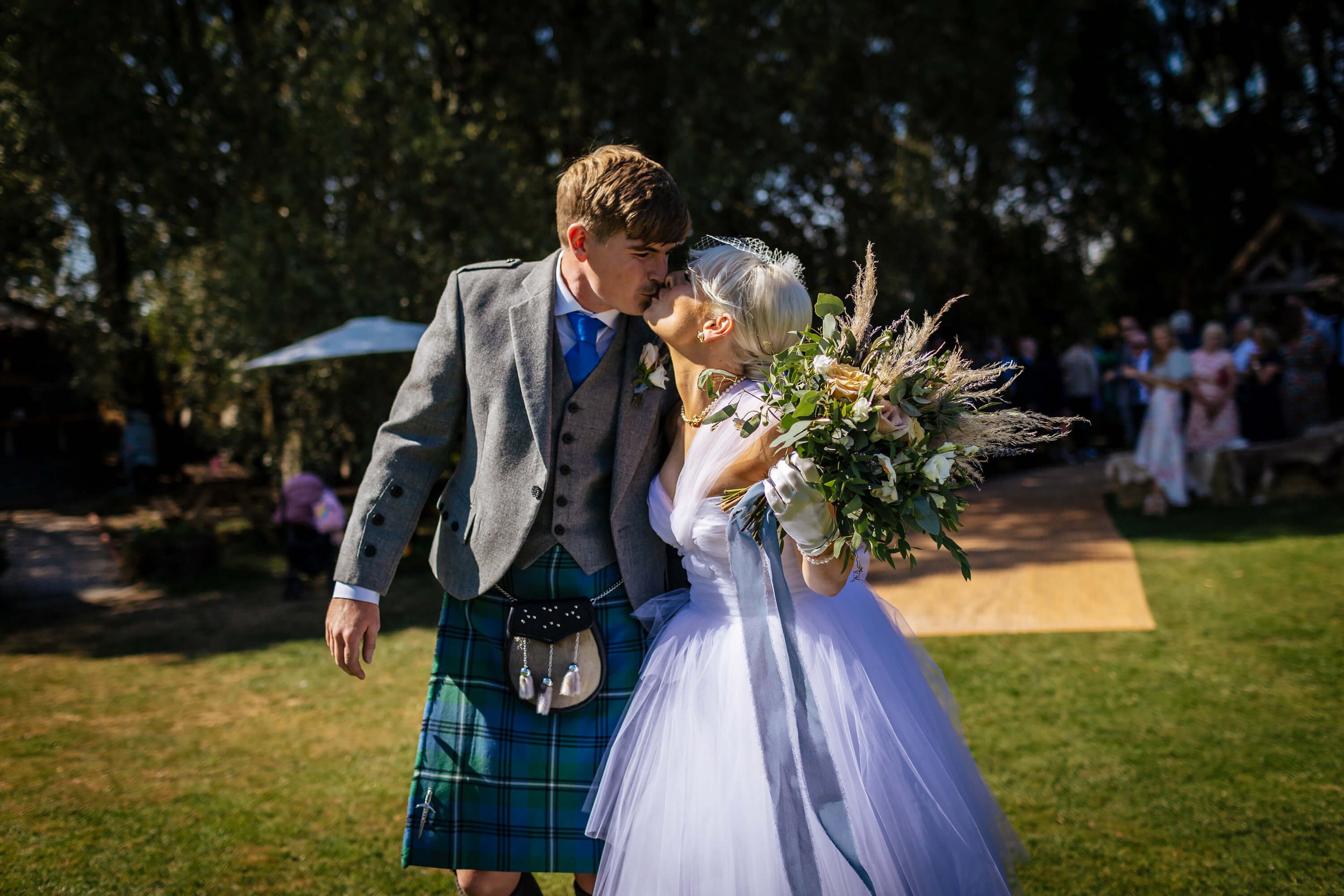 Bride and groom share a kiss at their wedding