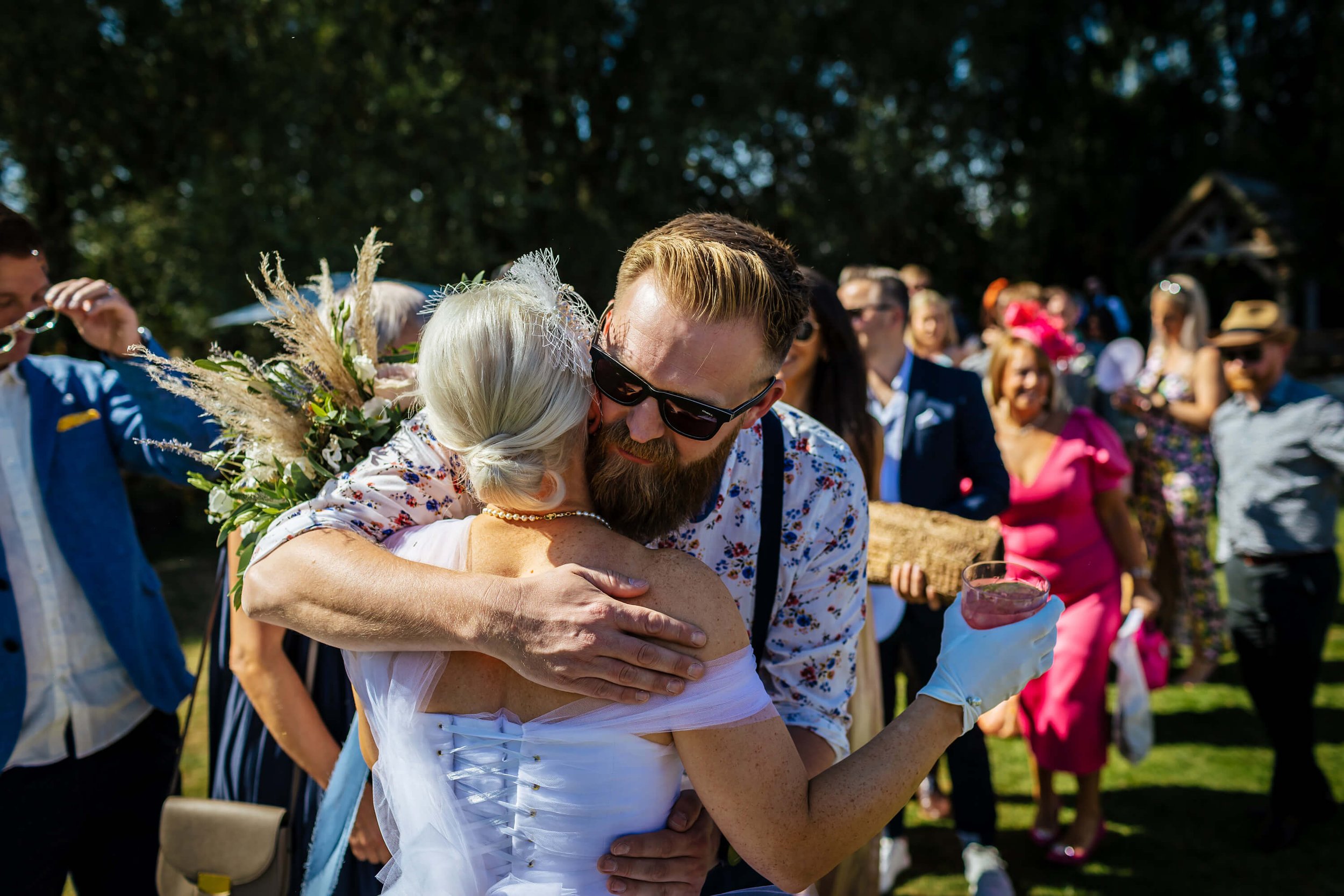 Wedding guest hugs the bride after her wedding ceremony