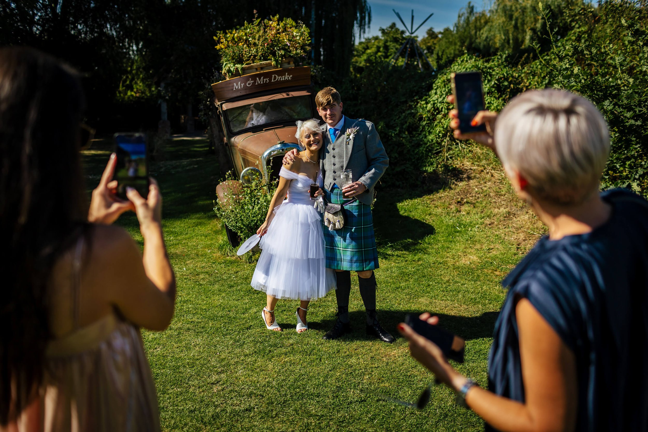 Guests taking photos of the bride and groom at Skipbridge Country Weddings