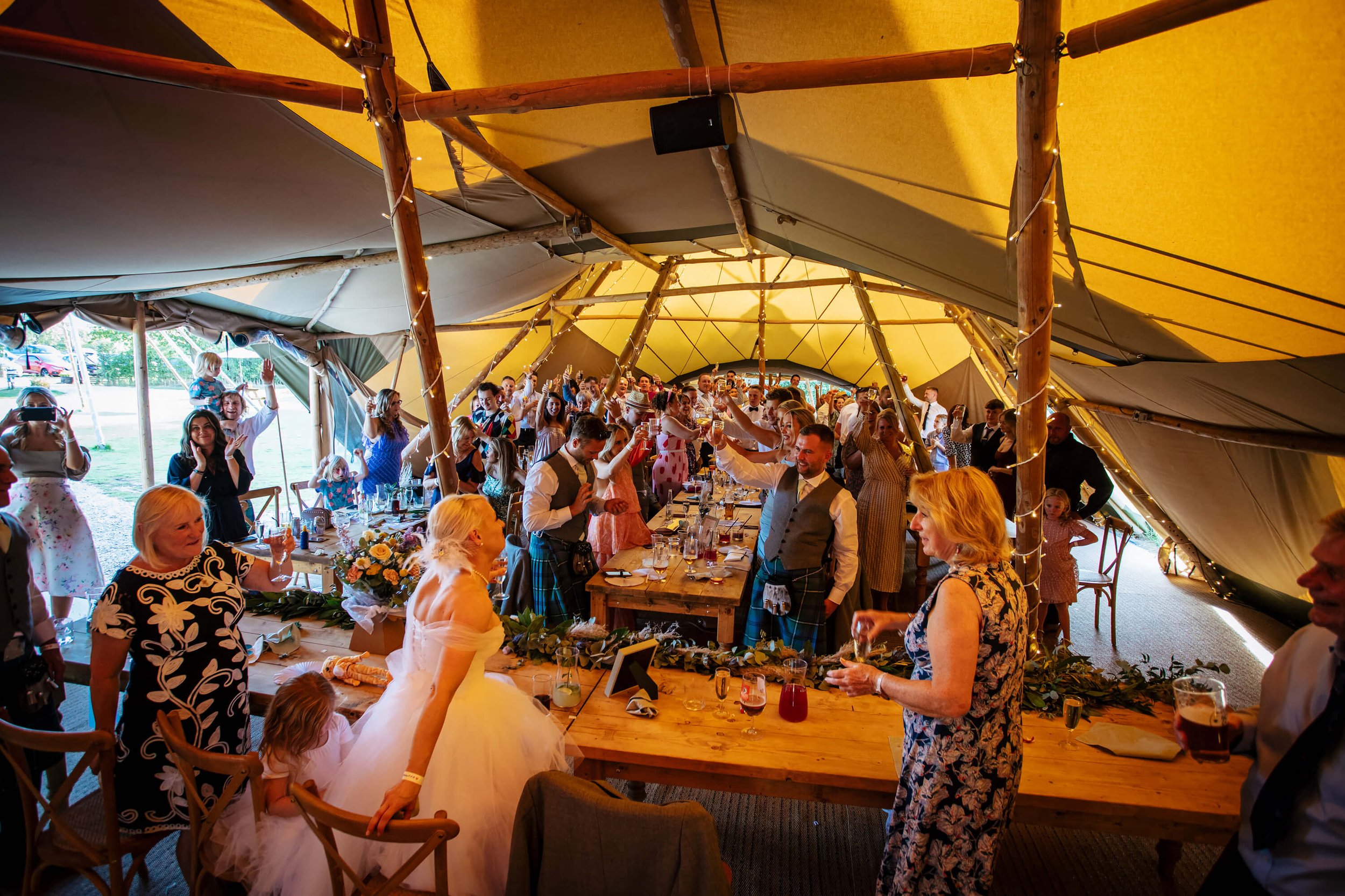 Toasting the speeches at a wedding in a marquee