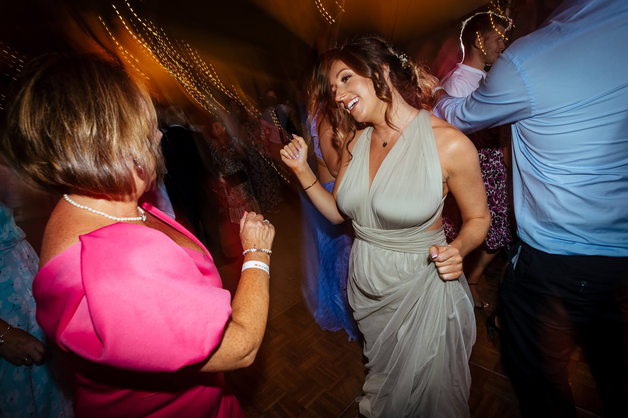 Bridesmaid dancing on the dance floor at a wedding reception