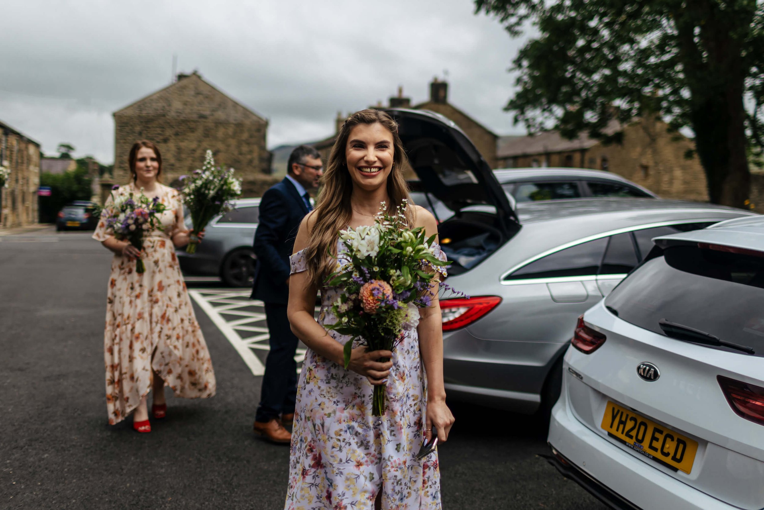 Bridesmaids with flowers as they arrive at the church in Skipton