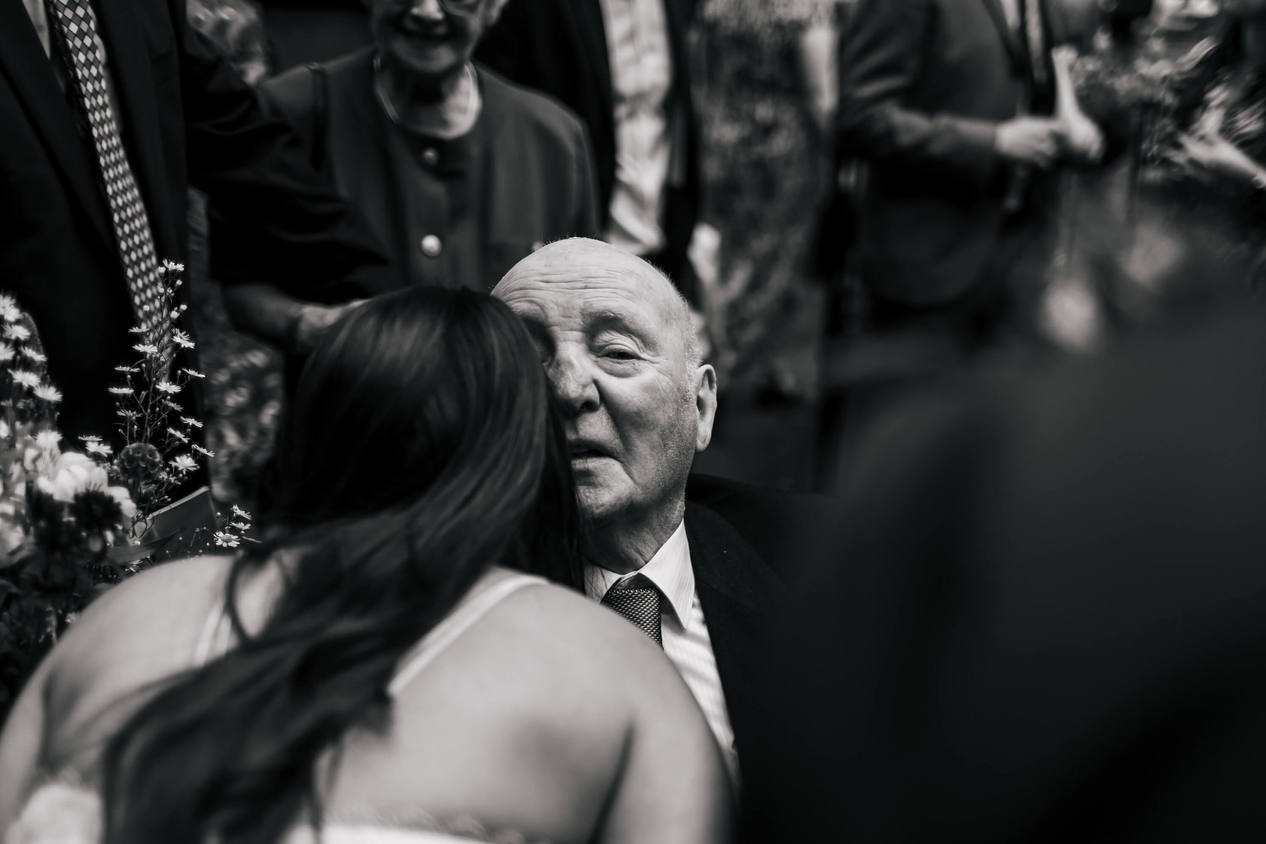 Bride and grandad hugging at the church after the wedding