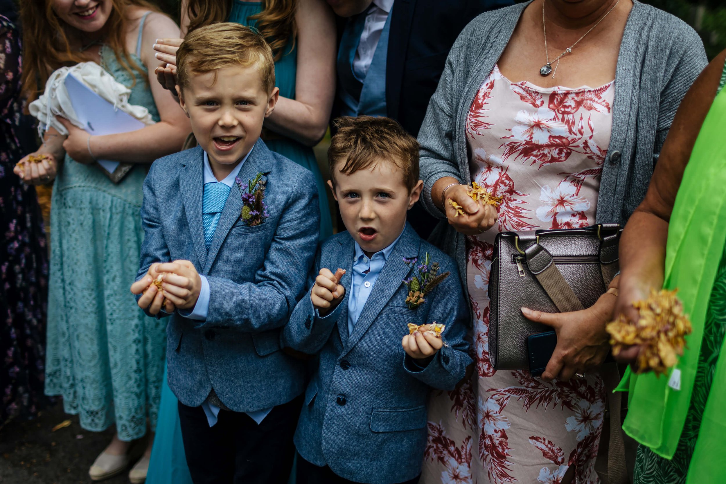 Young boys ready to throw the confetti at a wedding