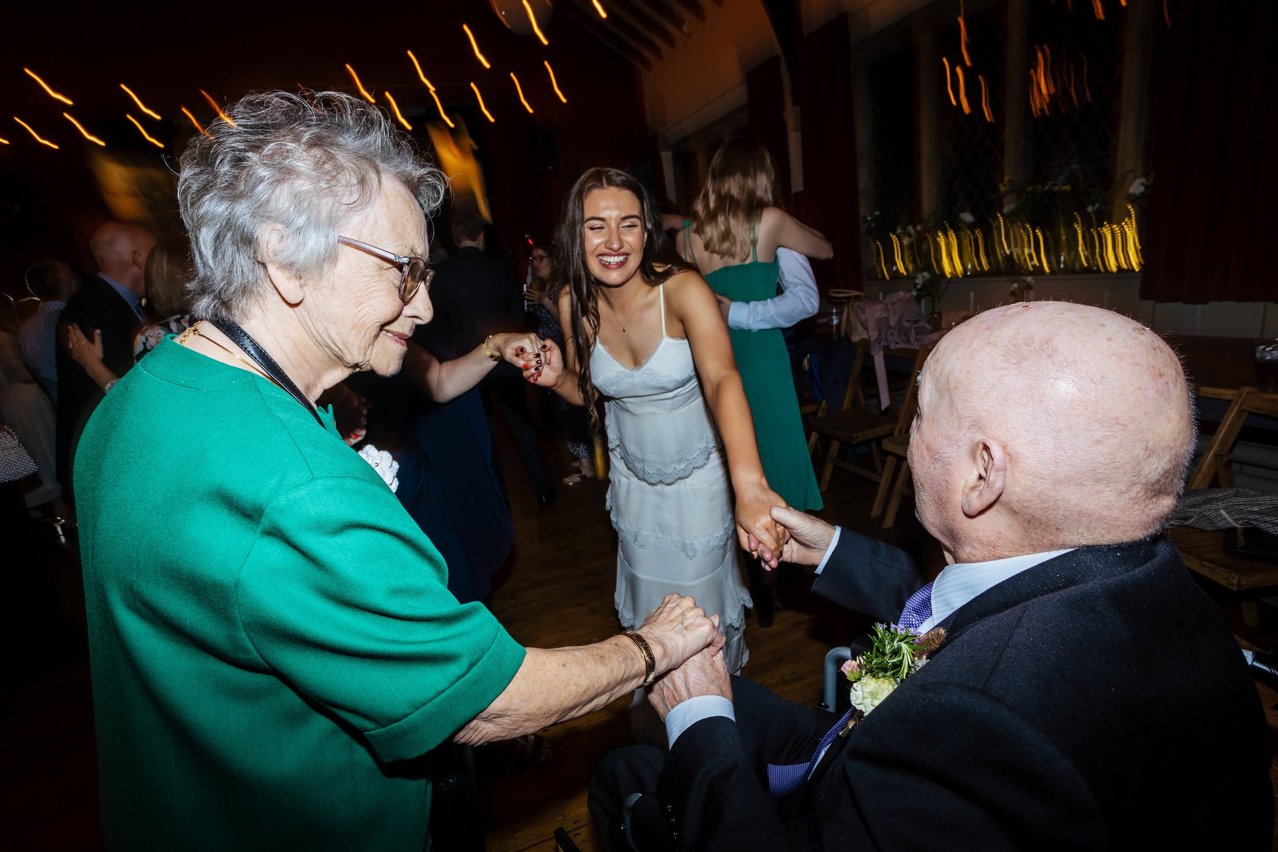 Bride dancing with her grandparents at the wedding