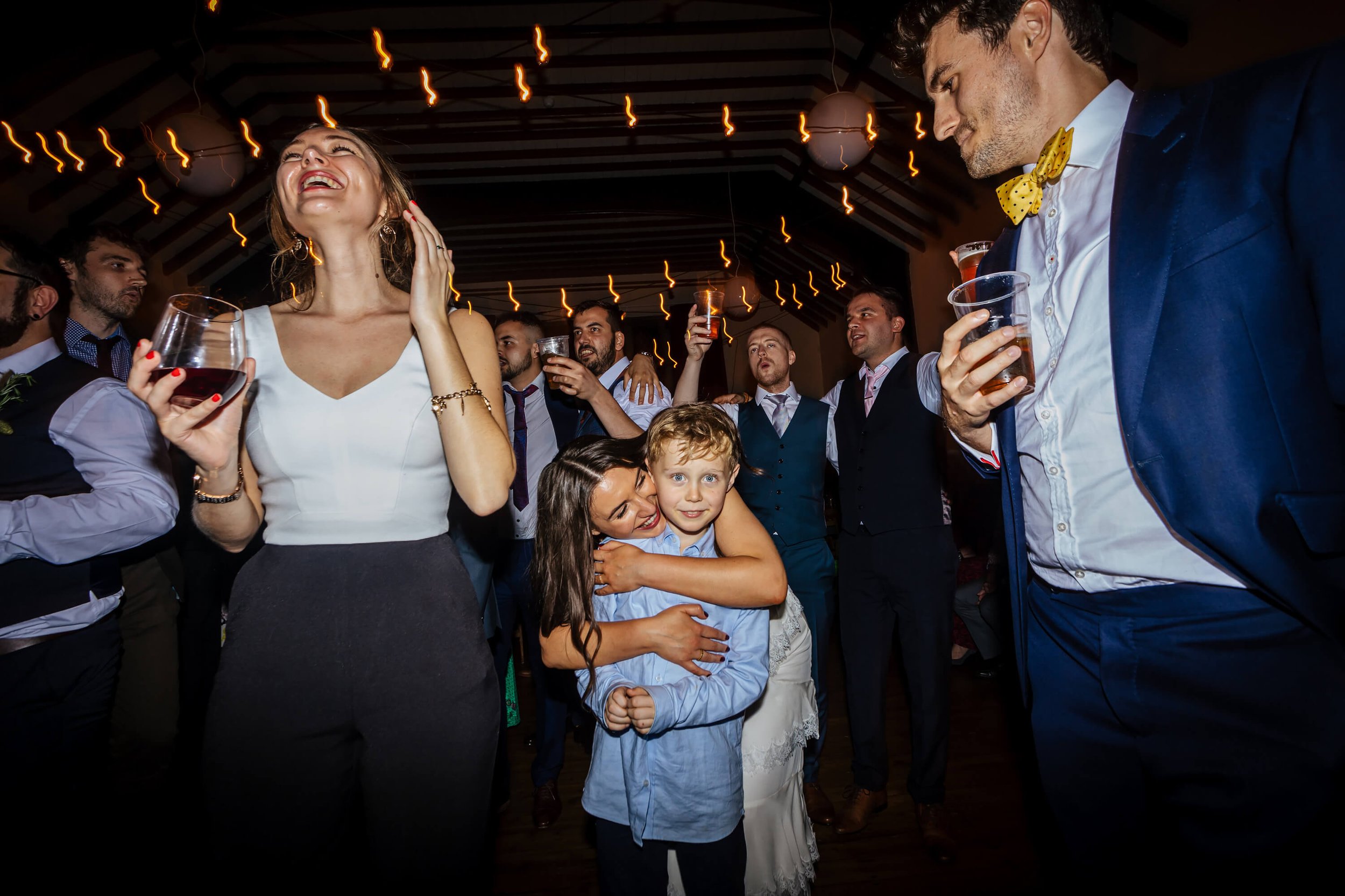 Bride and a young boy dancing at her Yorkshire wedding