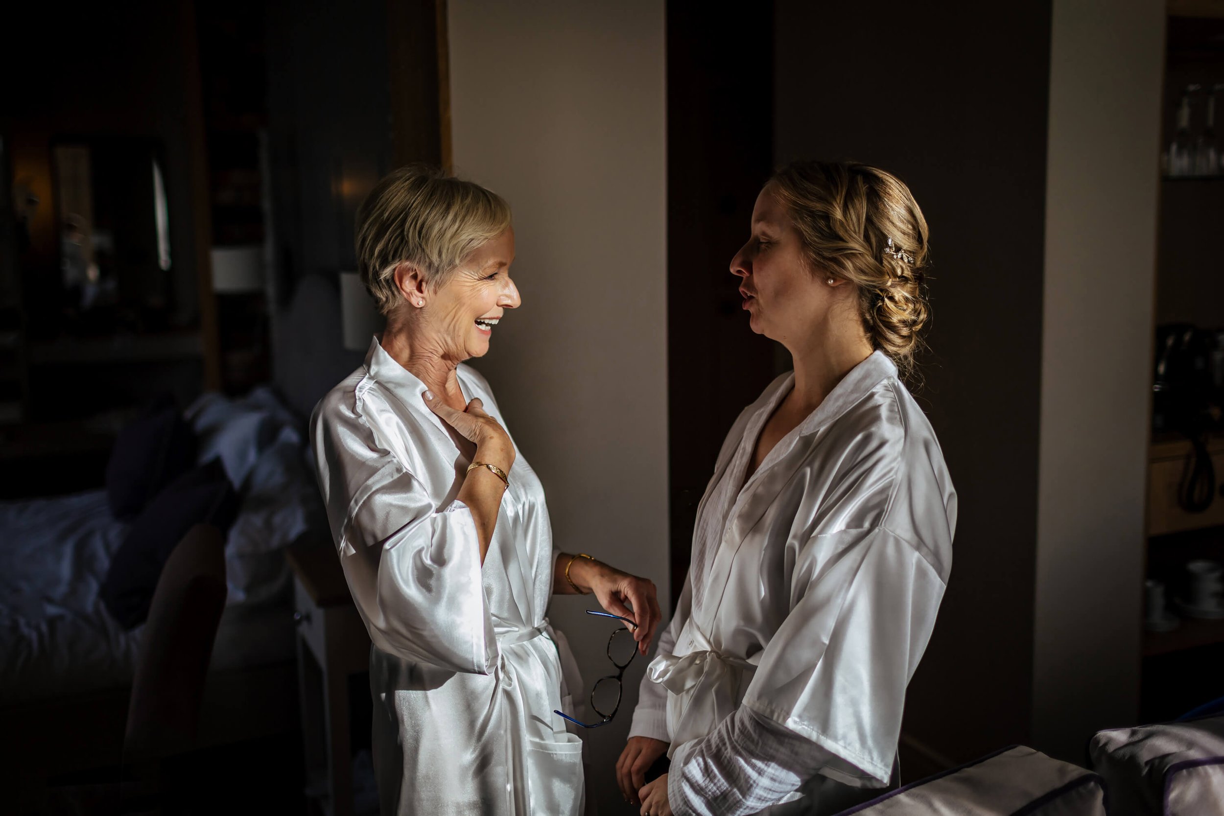 Bride and mum laughing on the wedding morning