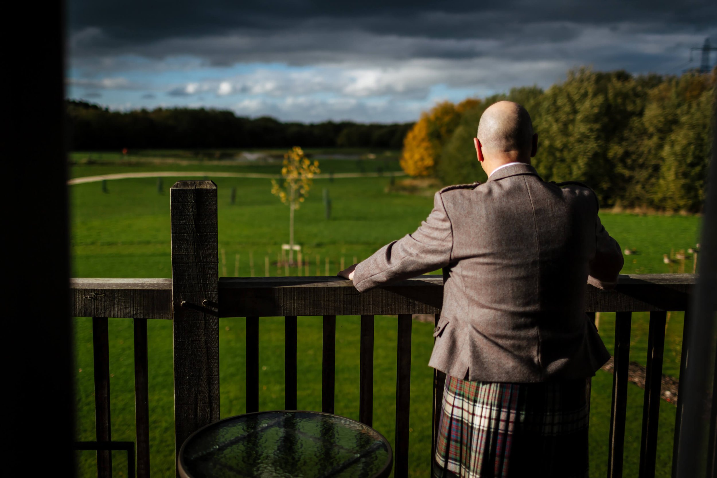 Bride's dad looking out over the golf course at Sandburn Hall