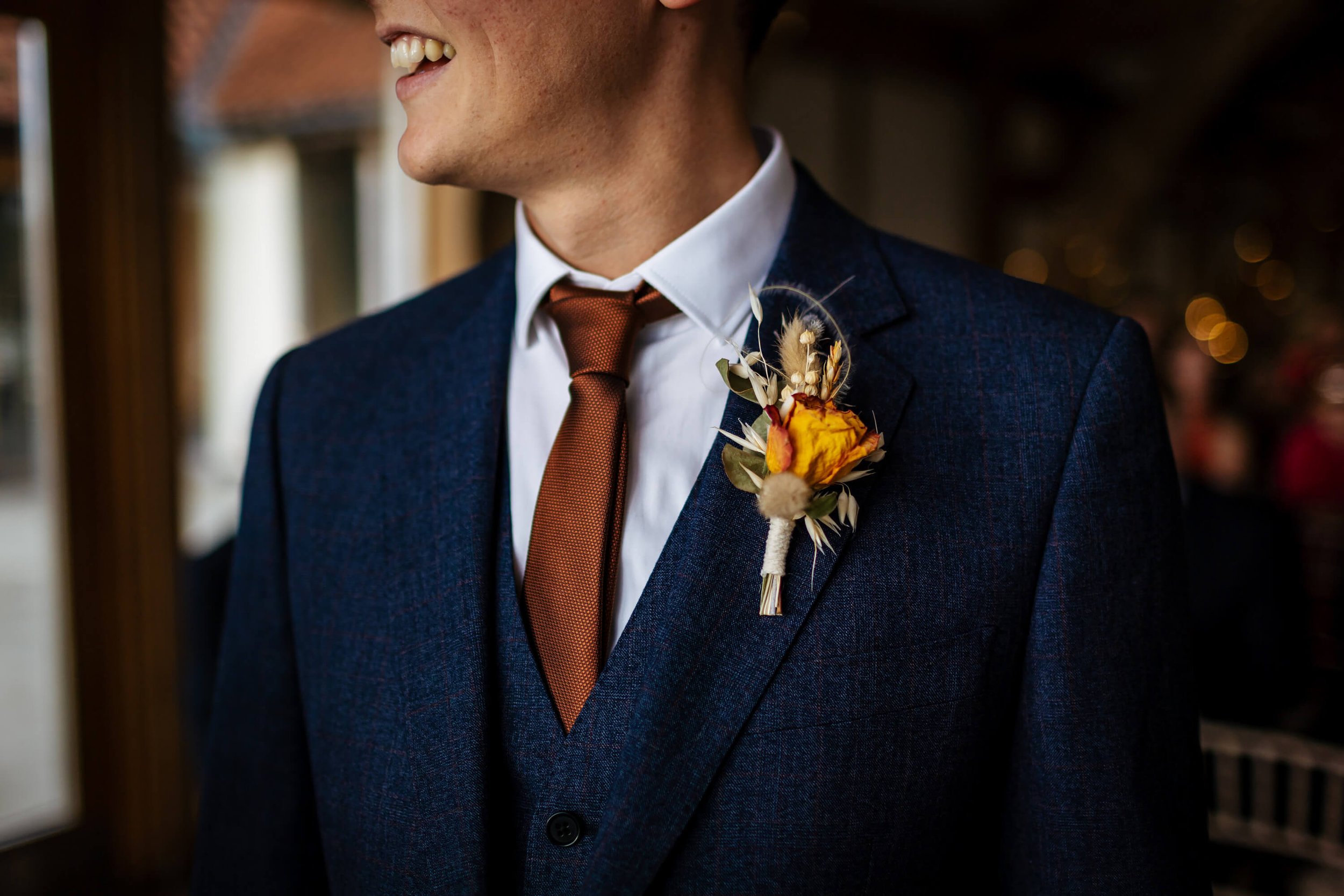 Close up of the groom and his buttonhole ready for the wedding