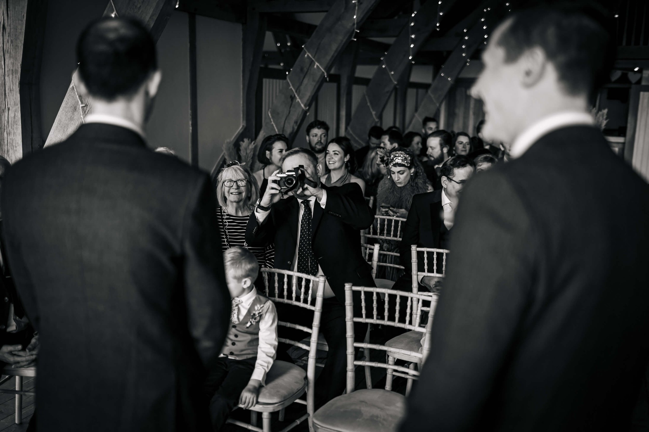 Wedding guest taking a photo of the groom and best man in York