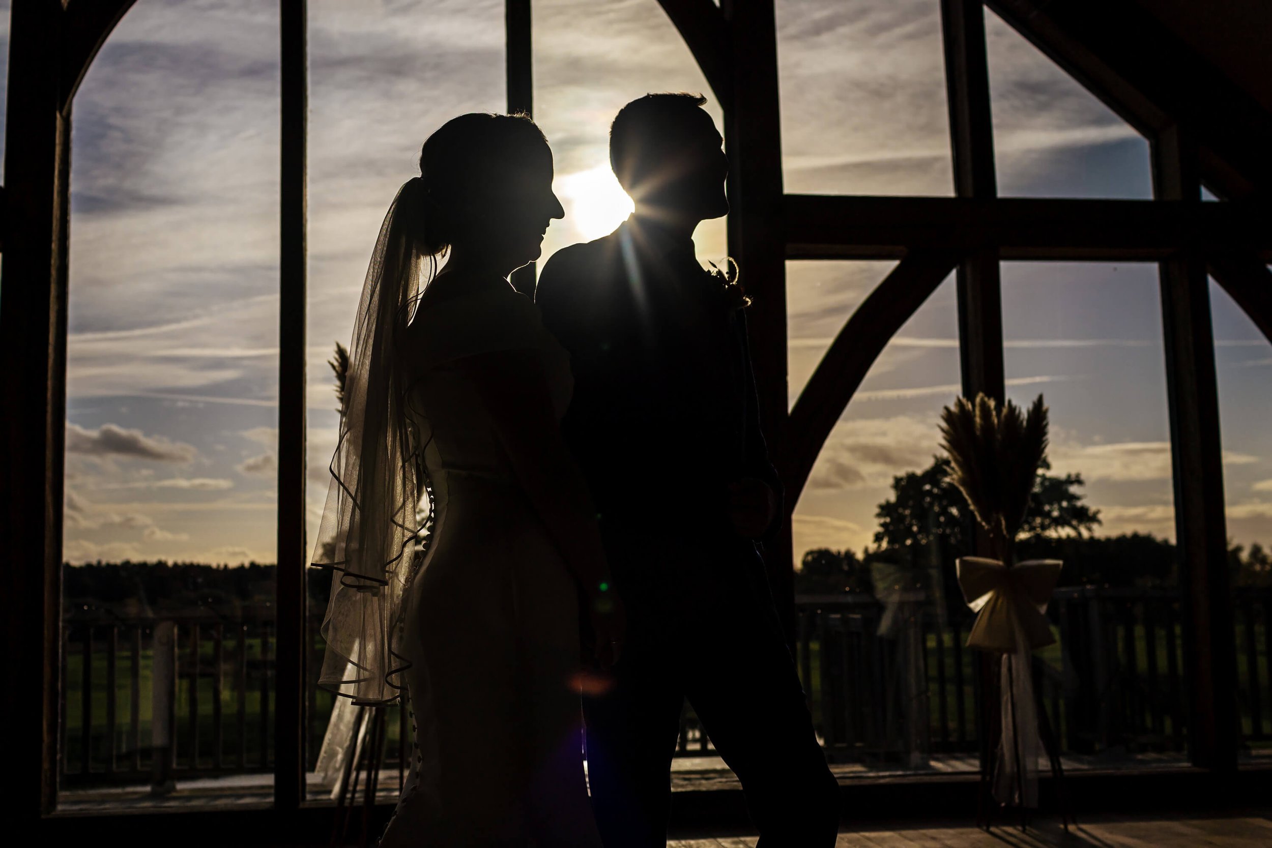 Silhouette of the bride and groom against the sunshine