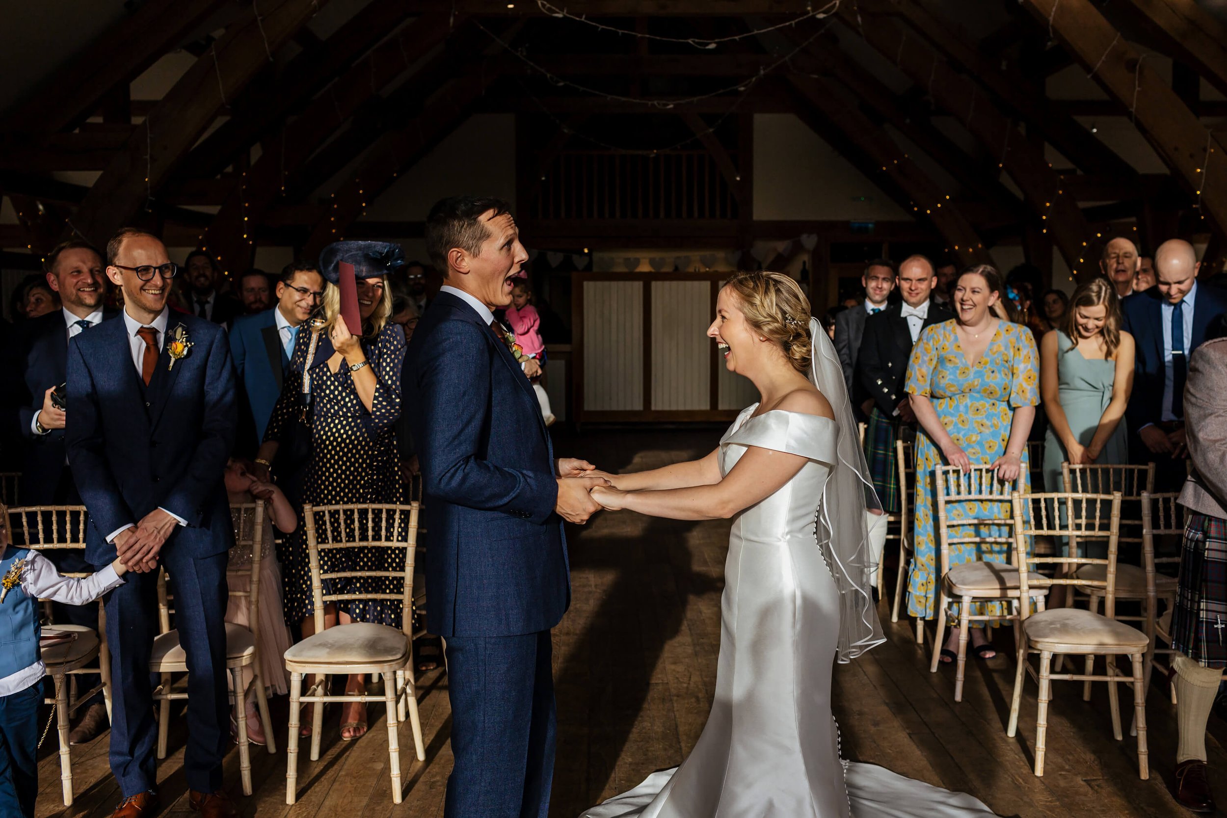 Bride and groom laugh during their wedding ceremony