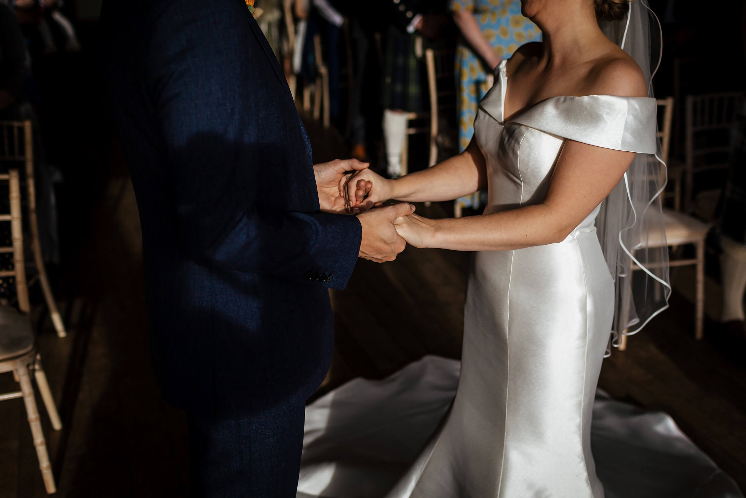 Newlyweds holding hands at a Sandburn Hall wedding