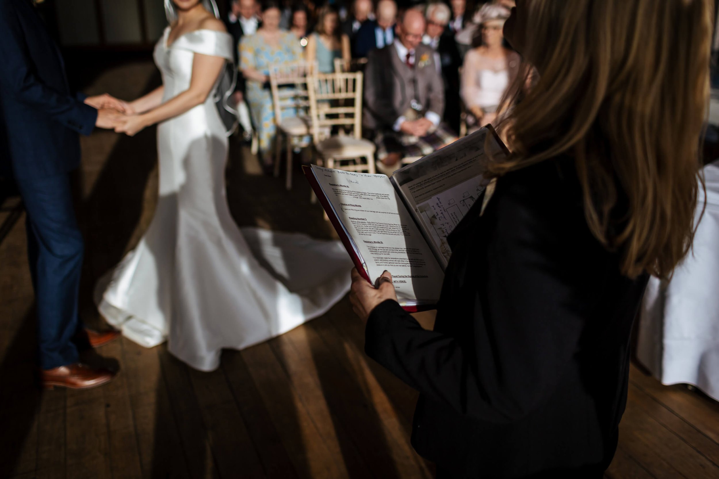 Registrar holds her notes during a wedding ceremony