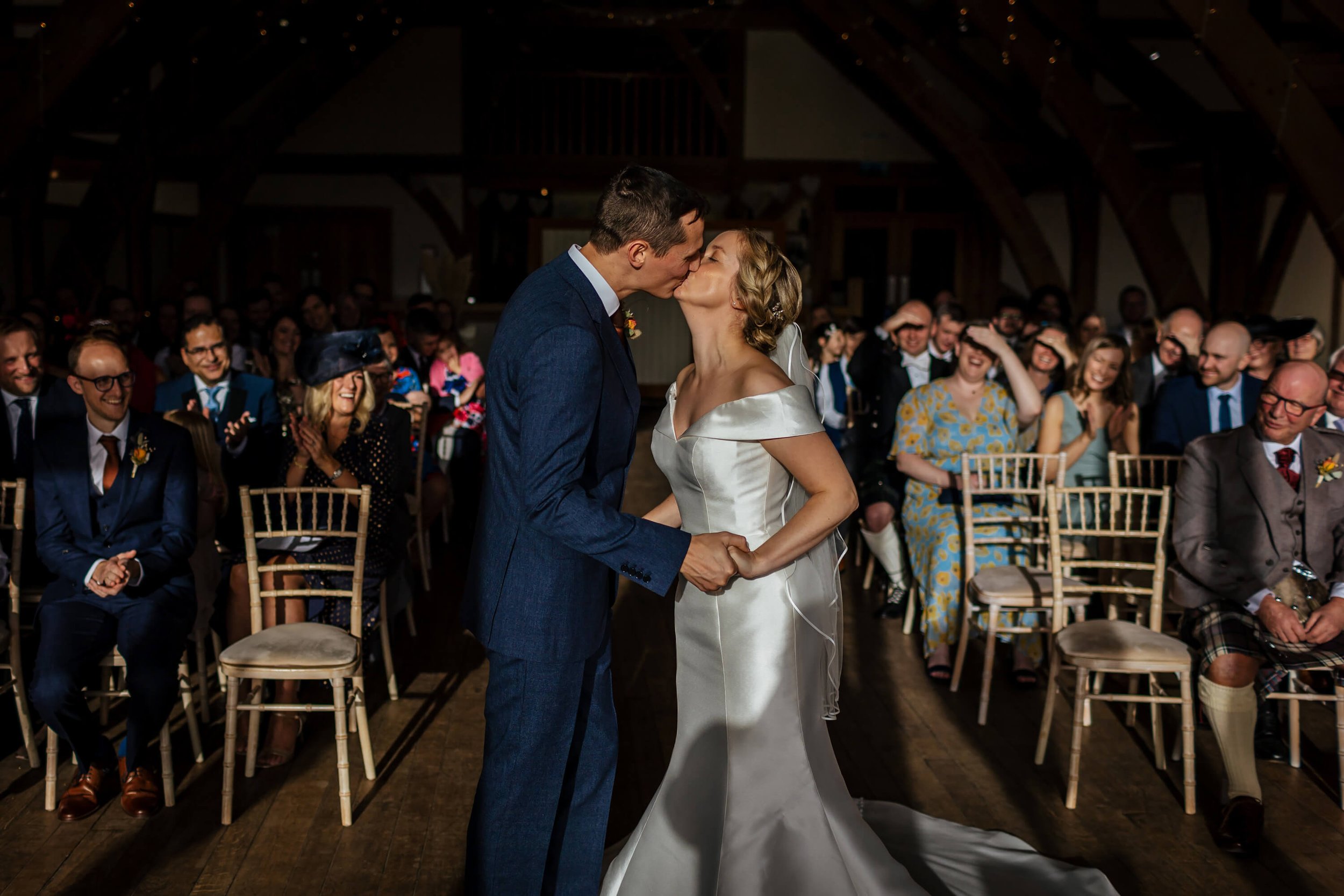 bride and groom's first kiss during their wedding ceremony