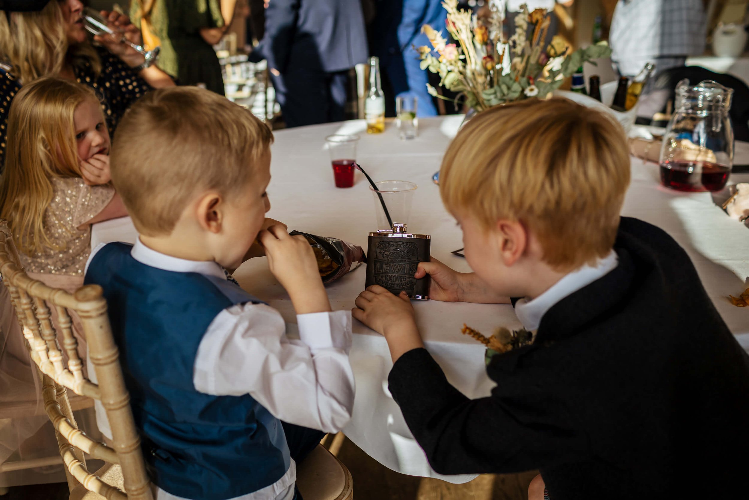 Young boy with a hip flask at a wedding in York