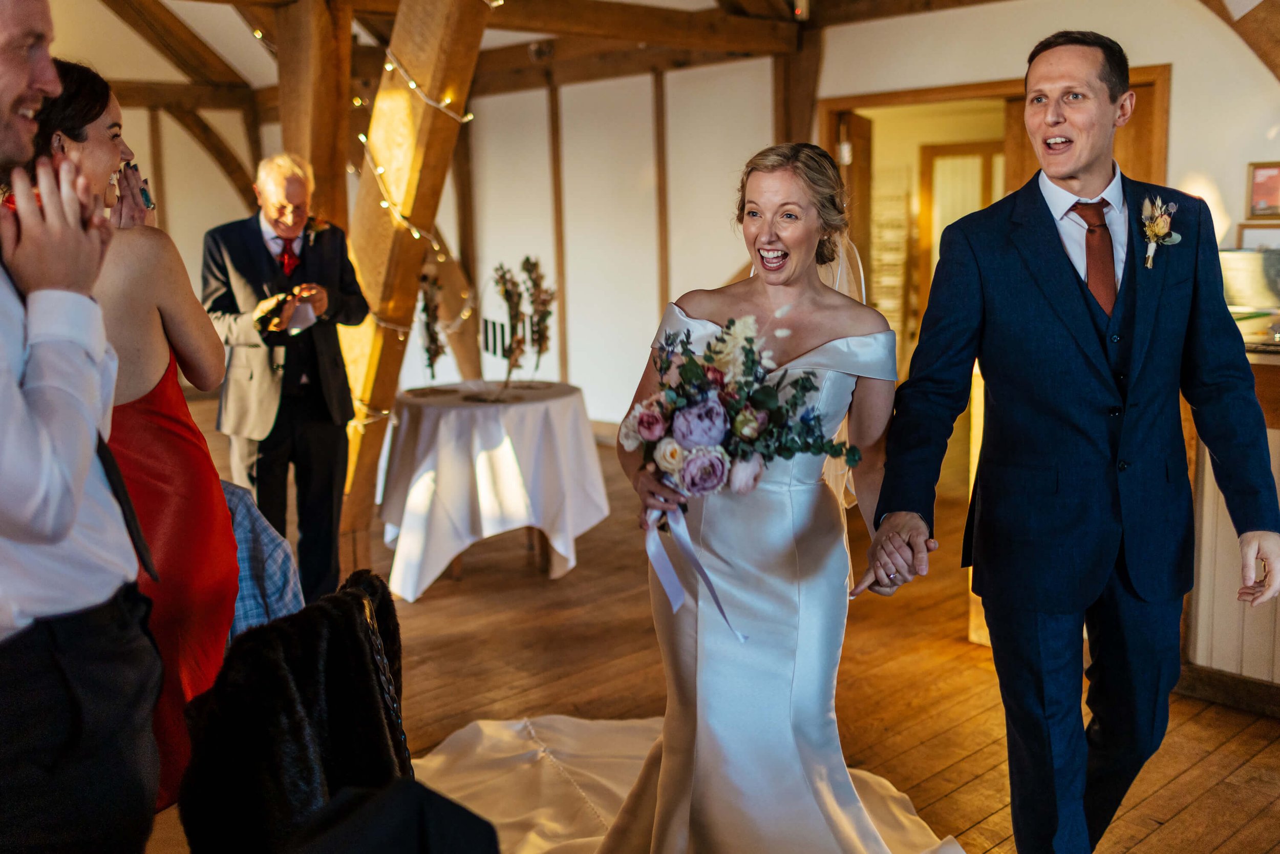 Bride and groom enter the reception room at their wedding