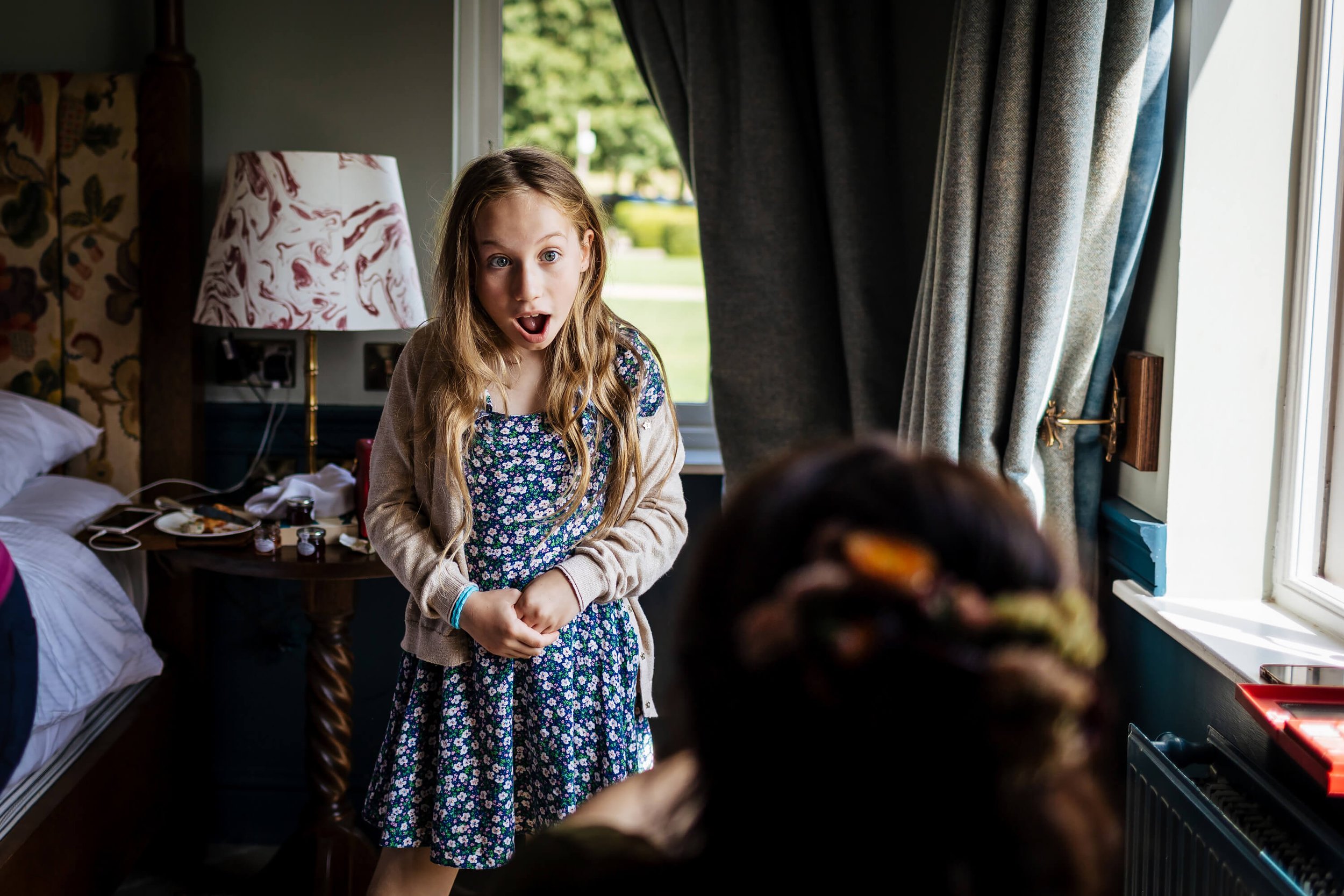 Bride's daughter looking shocked as her mum gets ready