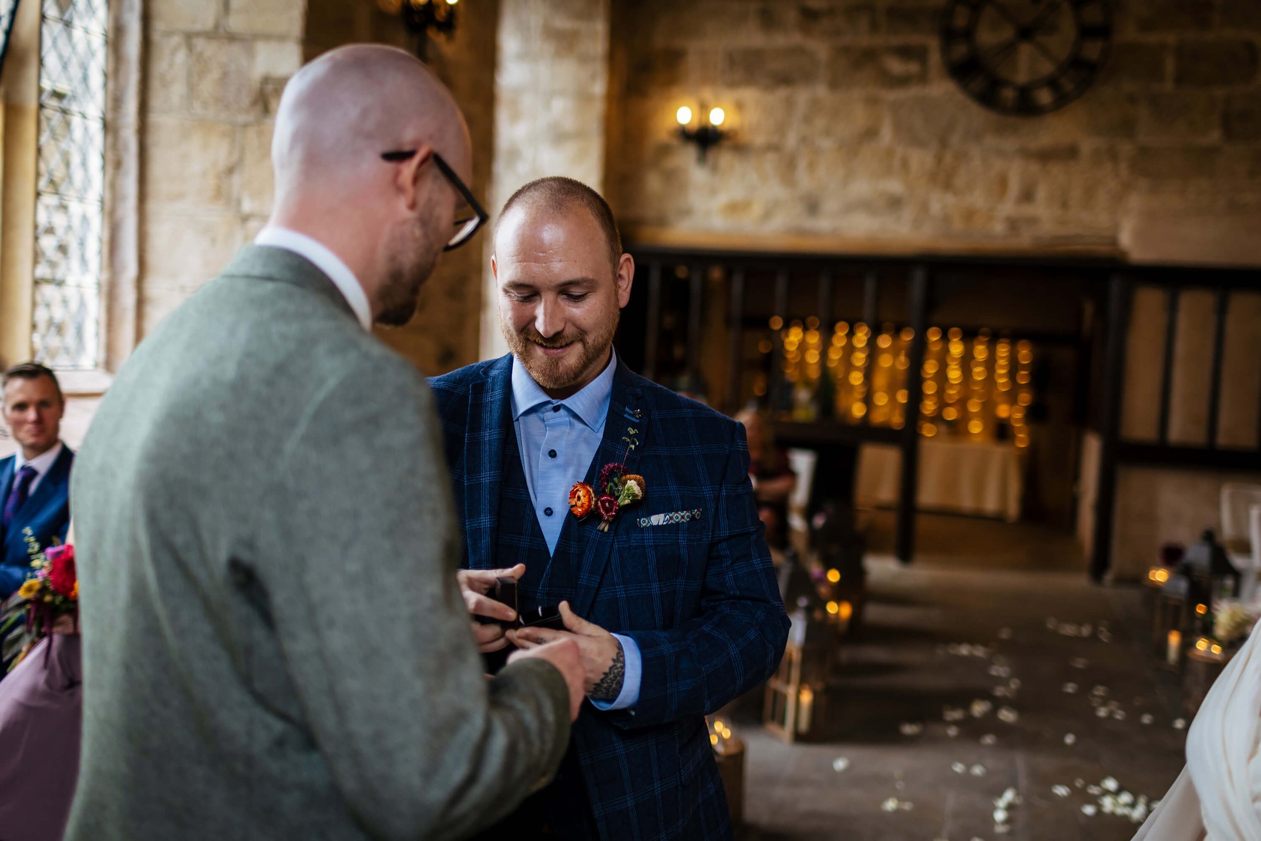 Best man presents the wedding rings to the groom