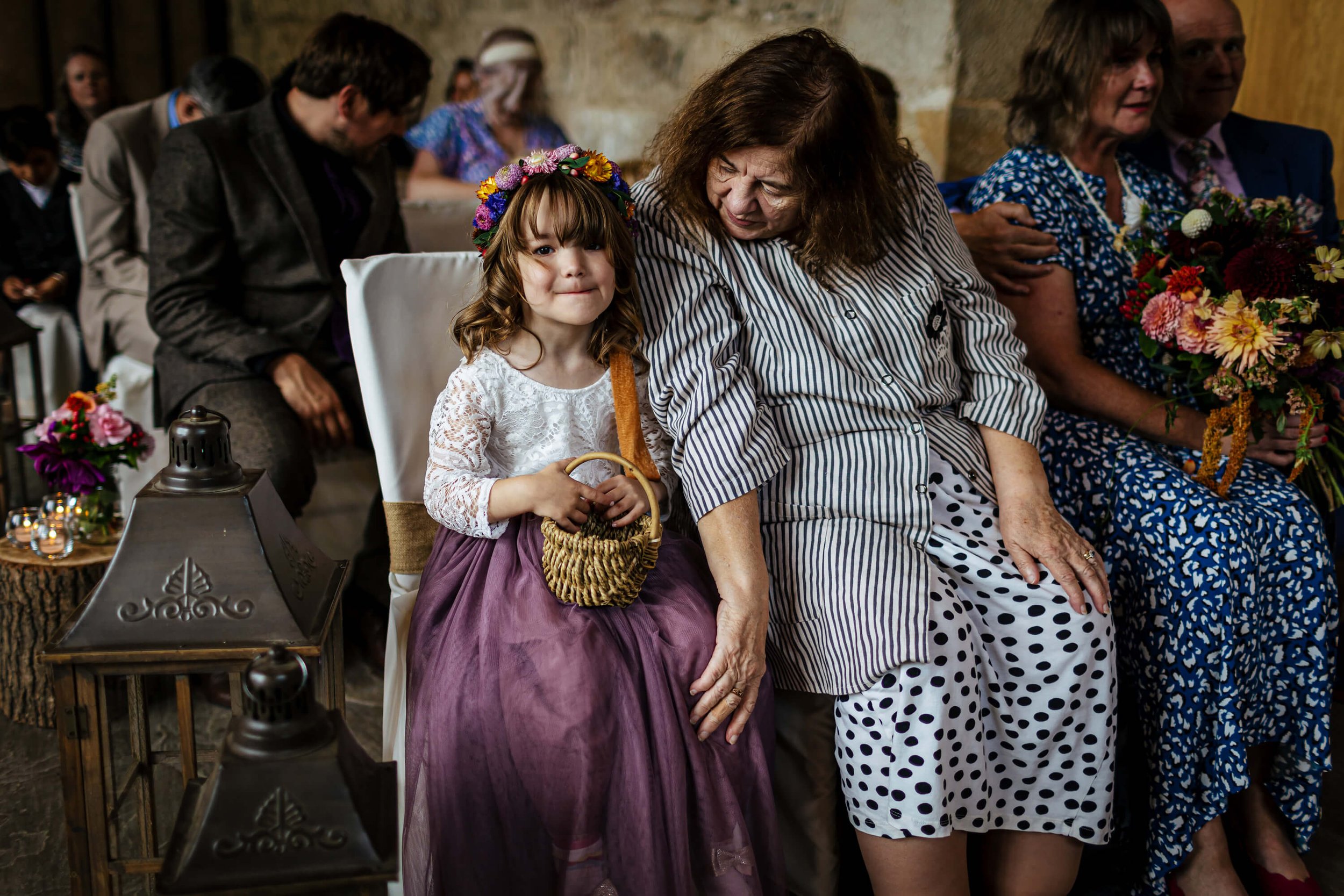 Flower girl smiling during the wedding service at Barden Tower