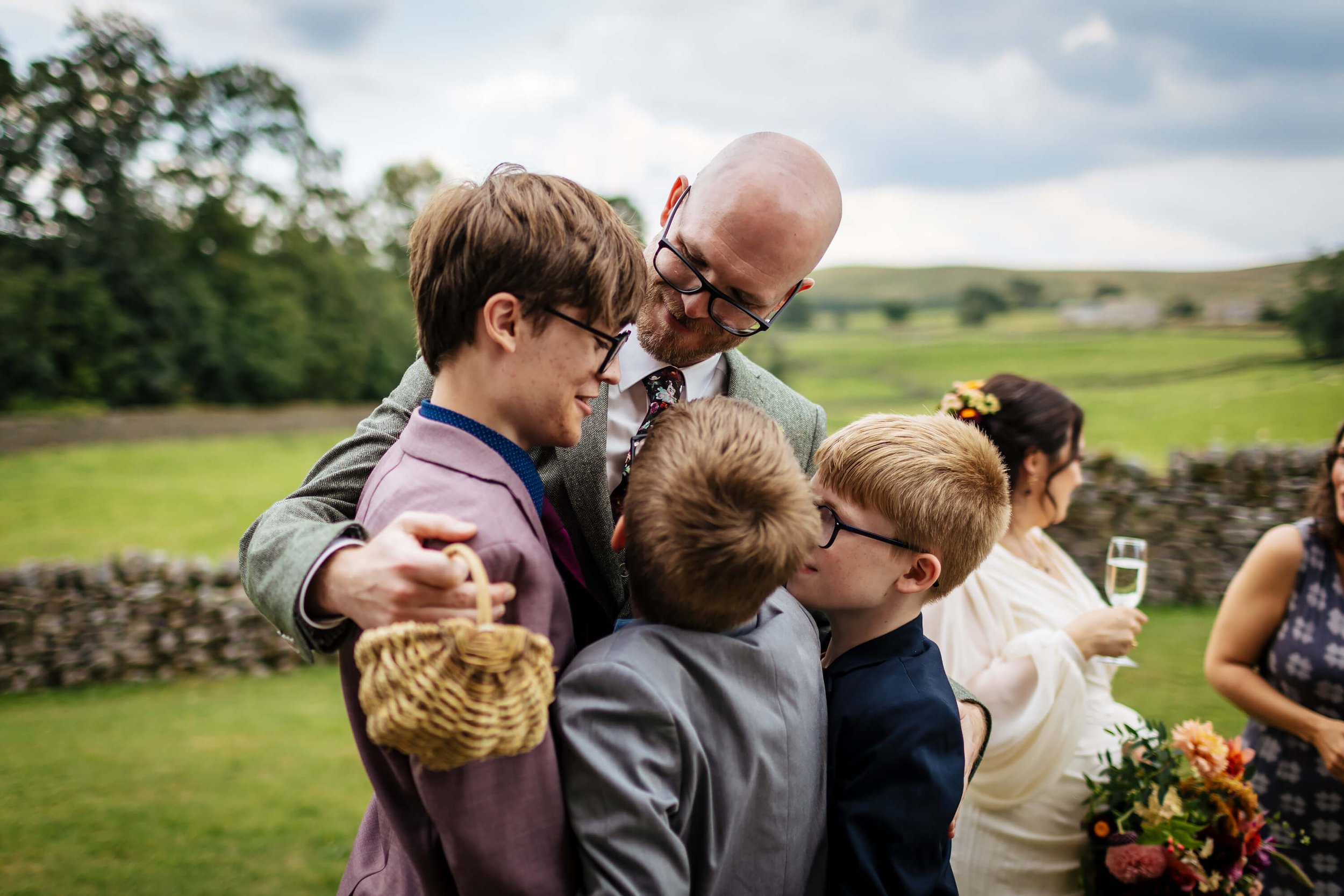 Groom and his sons share a moment after the wedding