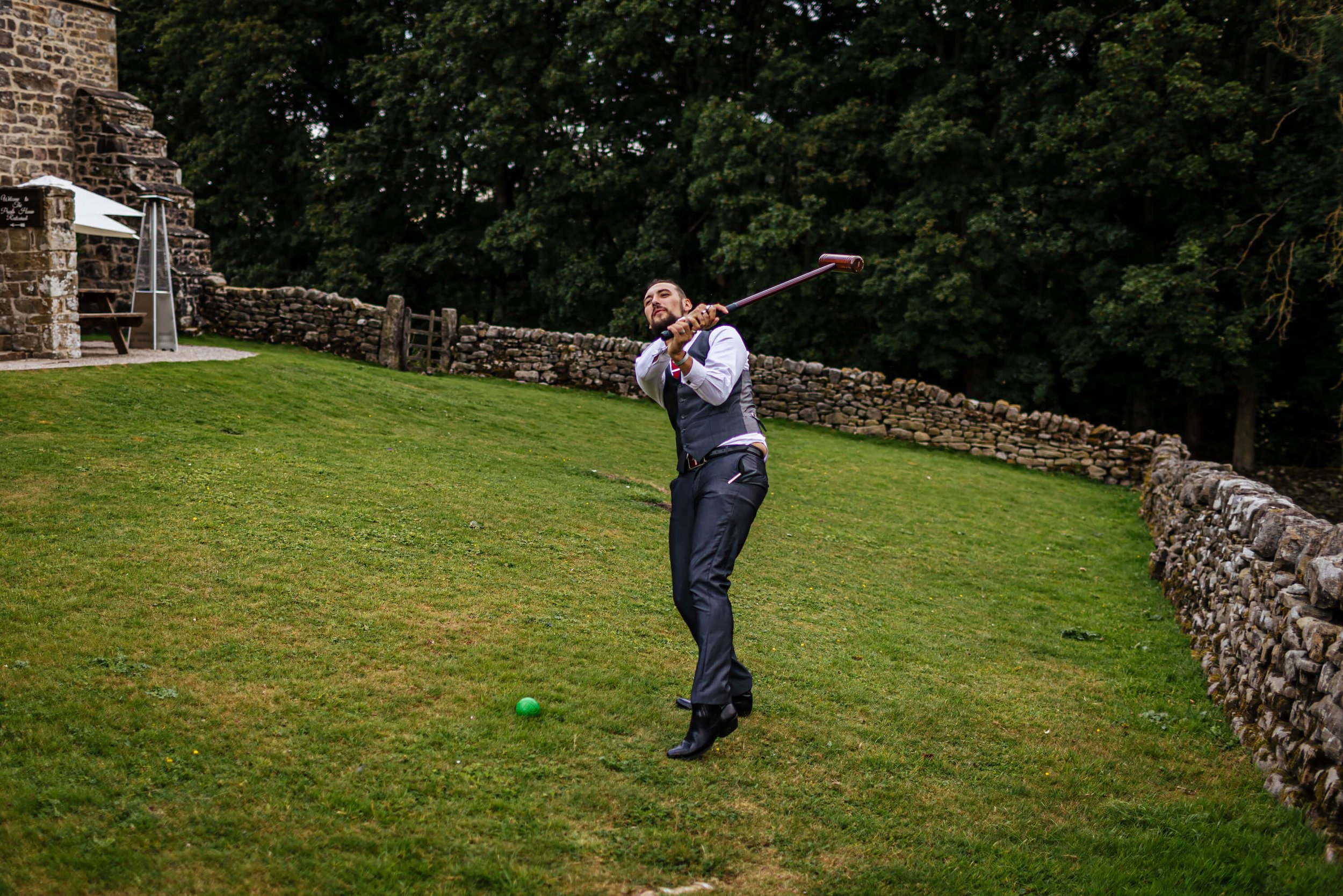 Wedding guest being irresponsible with the croquet club