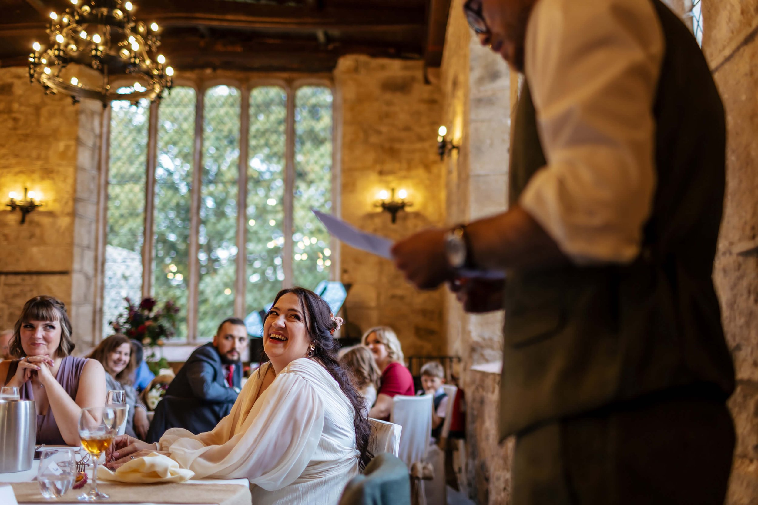 Bride laughing at her groom's wedding speech in Yorkshire