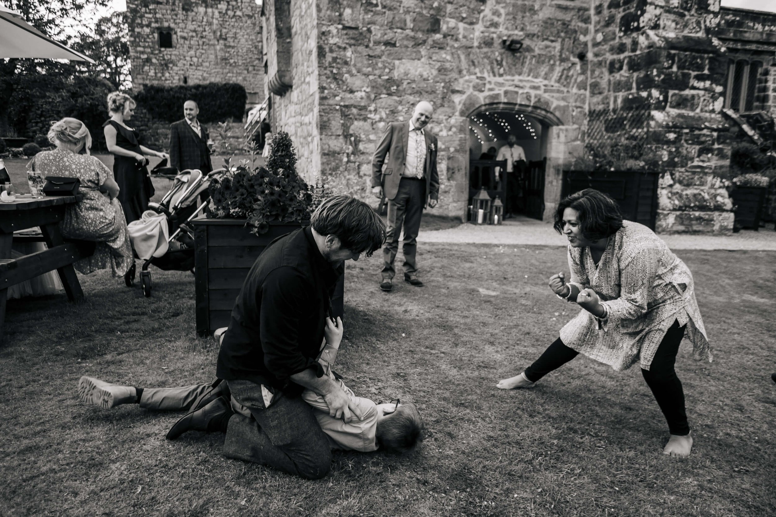 Wedding guests play fighting at Barden Tower