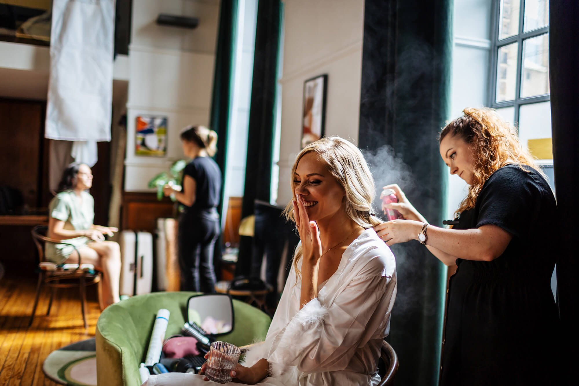 Hairdresser gets to work with the bride for a wedding