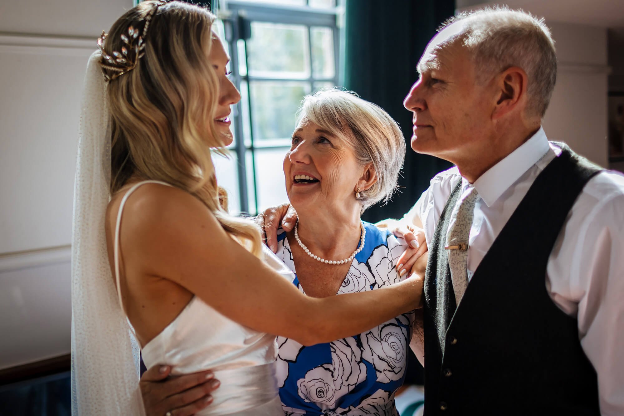Bride with her mum and dad on the wedding morning London
