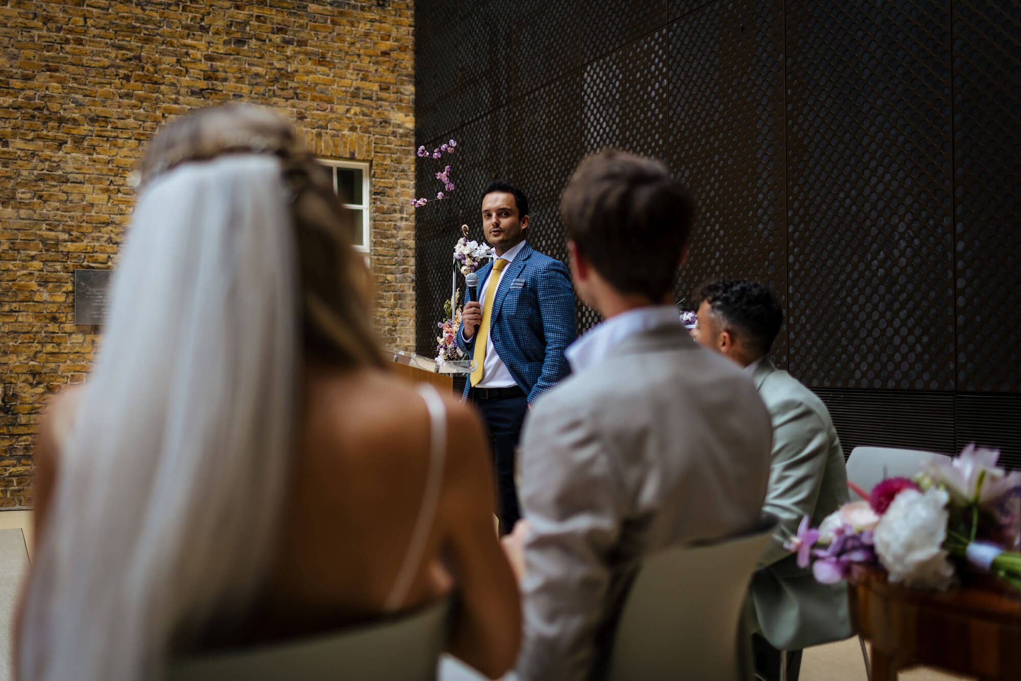 A wedding guests performs a reading during the service