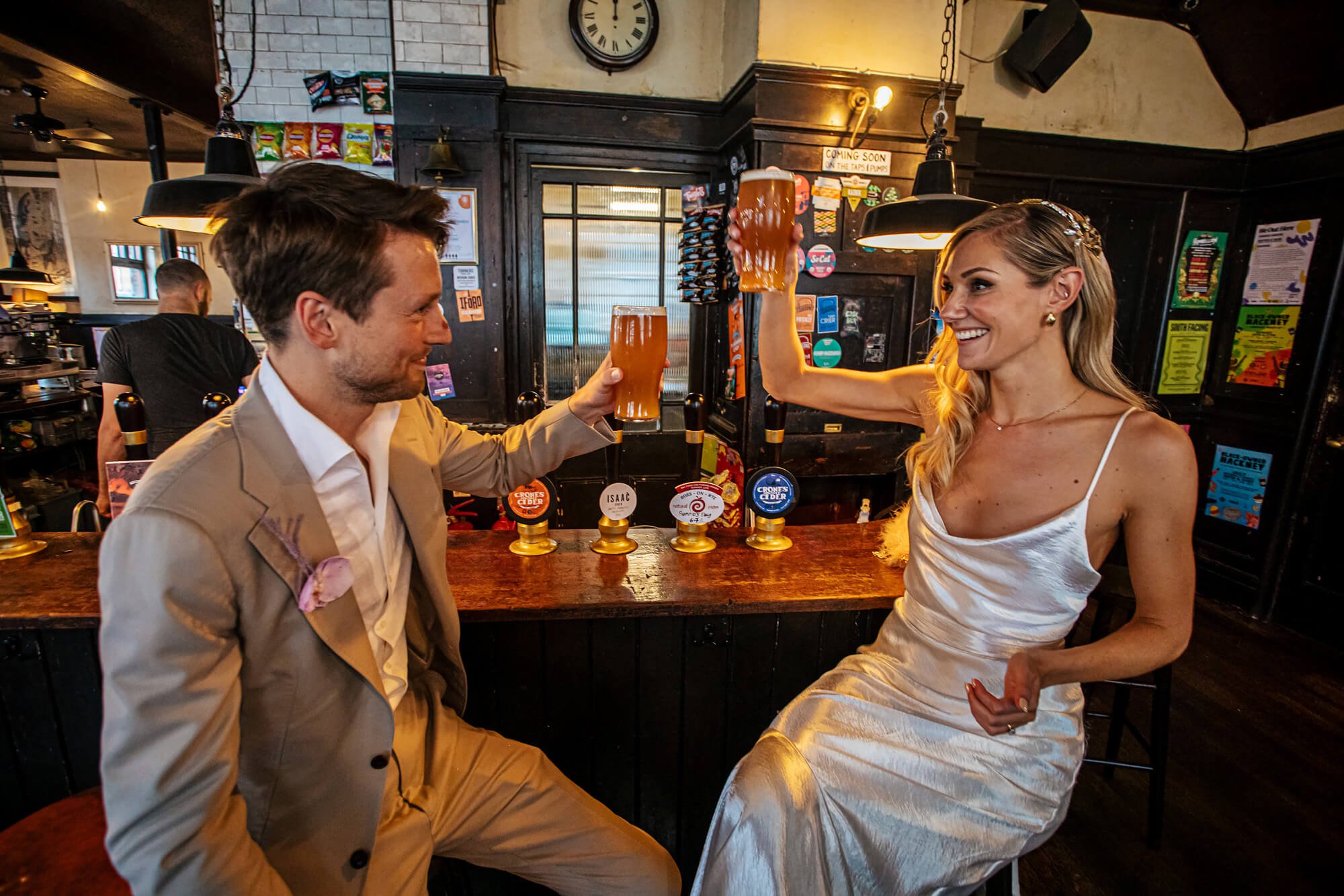 Bride and groom have a pint in London after their wedding ceremony