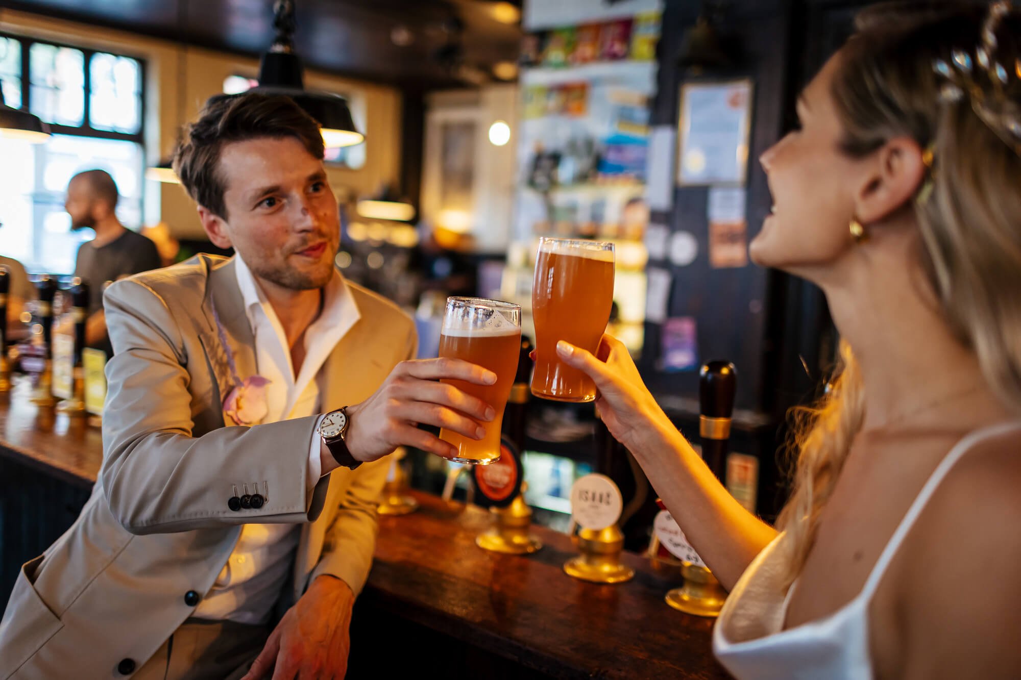 Newlyweds having a pint on their wedding day, cheers!