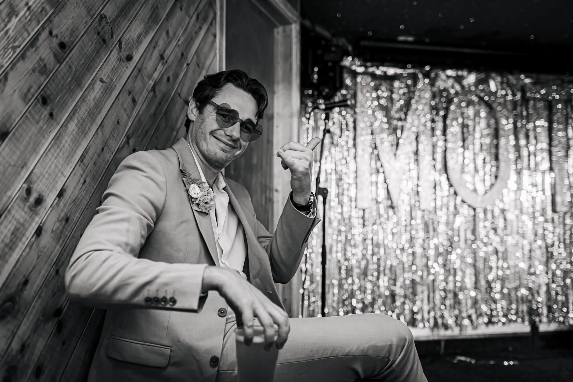 Best man strikes a pose at a wedding