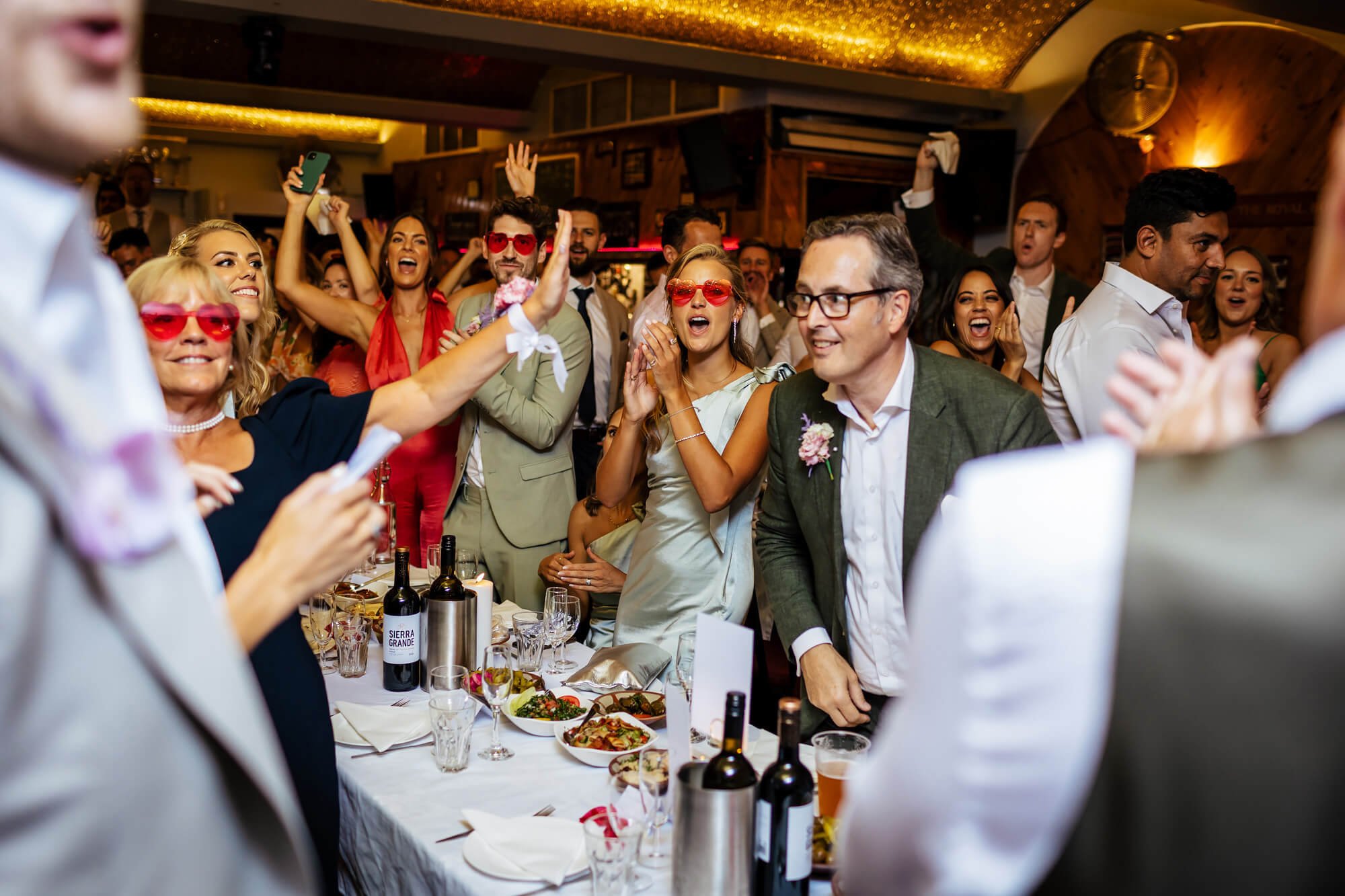 Wedding guests cheering during the speeches at MOTH Club