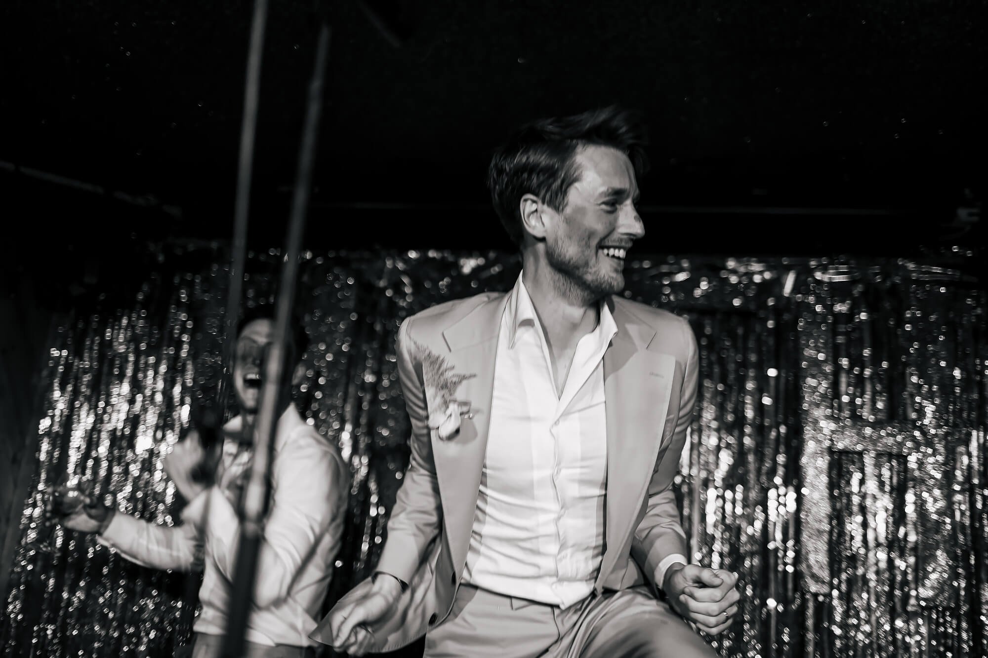 Groom dancing on the stage at a MOTH Club wedding