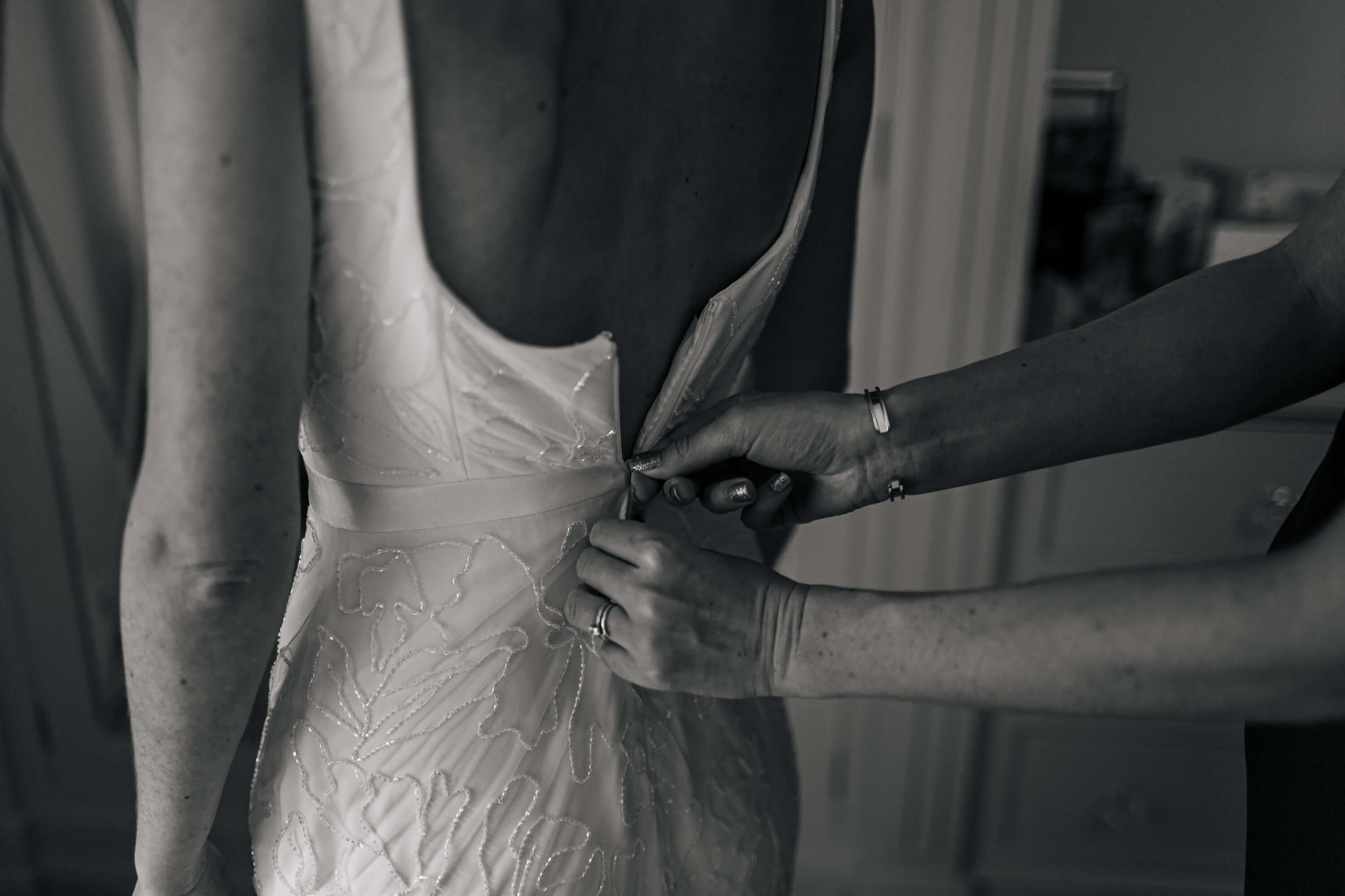 Fastening the bride's wedding dress before the ceremony