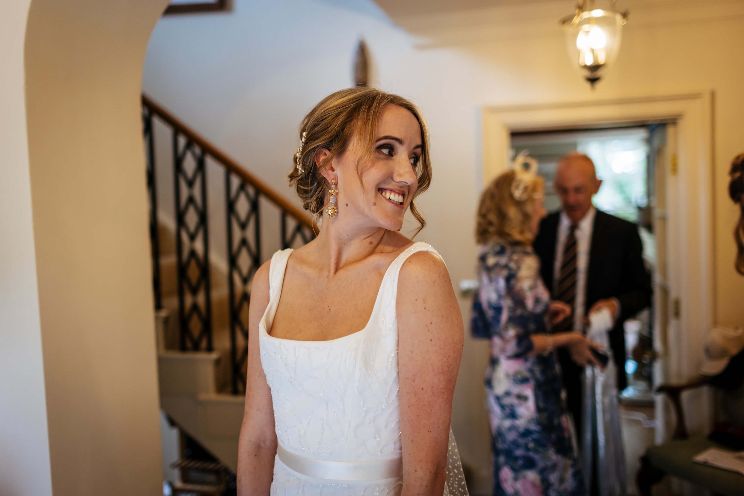 Bride admiring herself in the mirror on the morning of her wedding