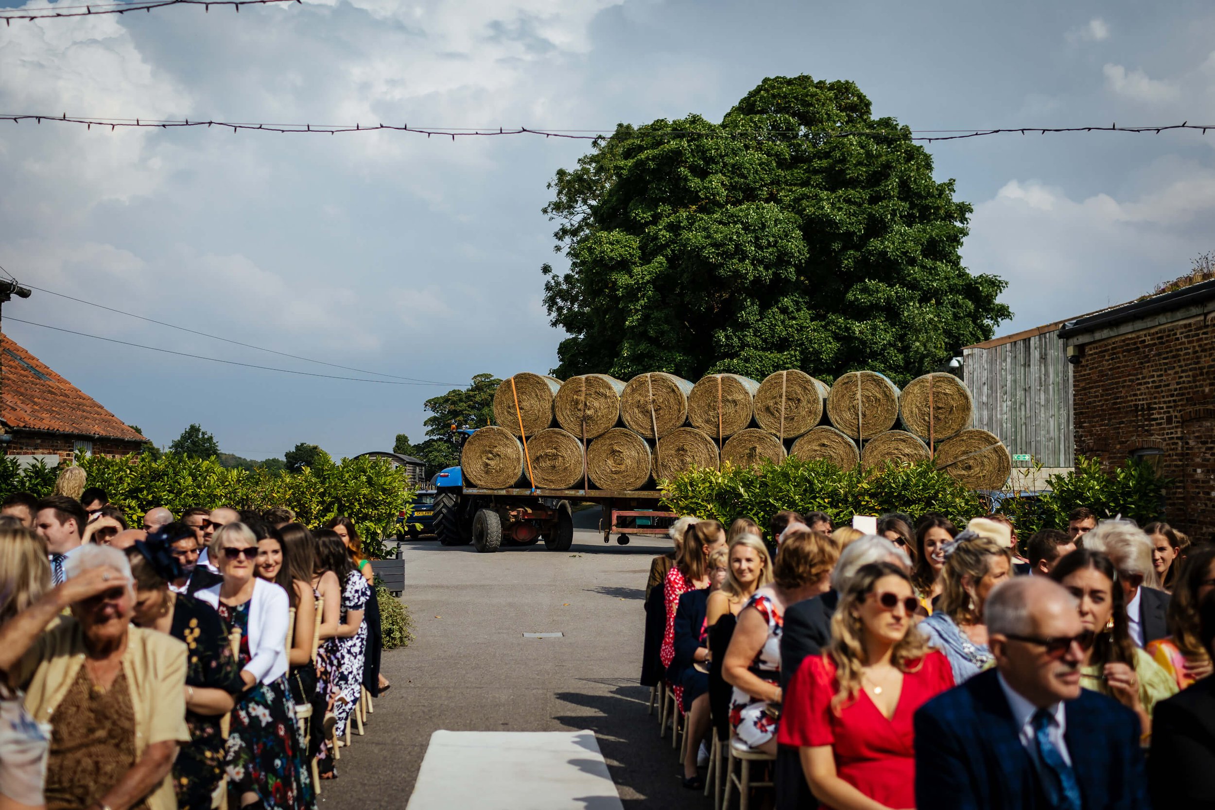 Tractor with hay bails interrupting a wedding cermeony