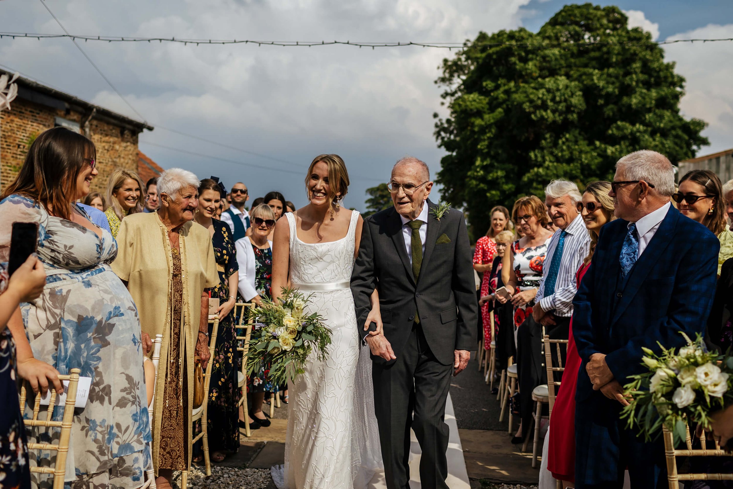 Bride and dad walk down the aisle at a Hornington Manor wedding