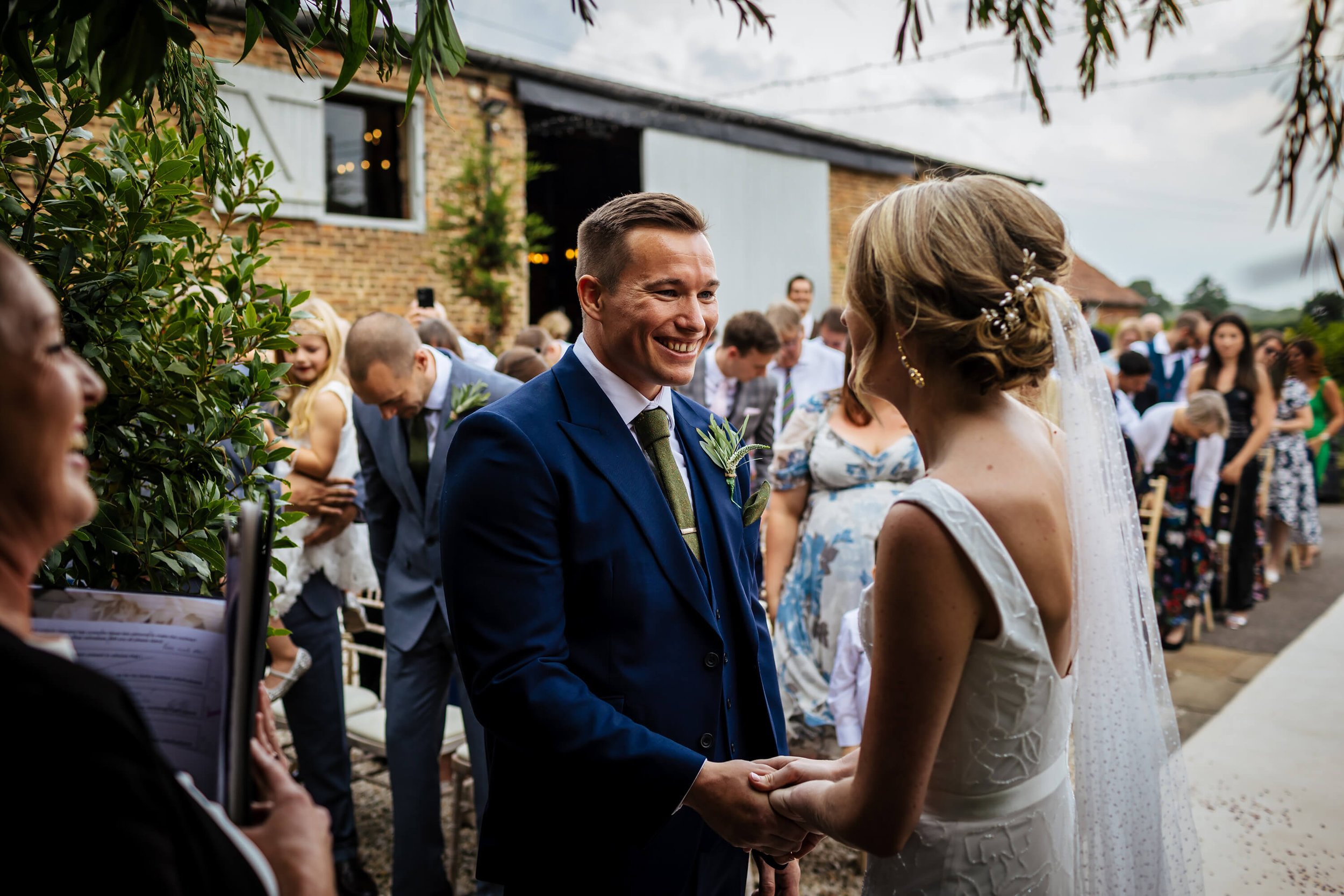 Groom smiles during his wedding ceremony at Hornington Manor