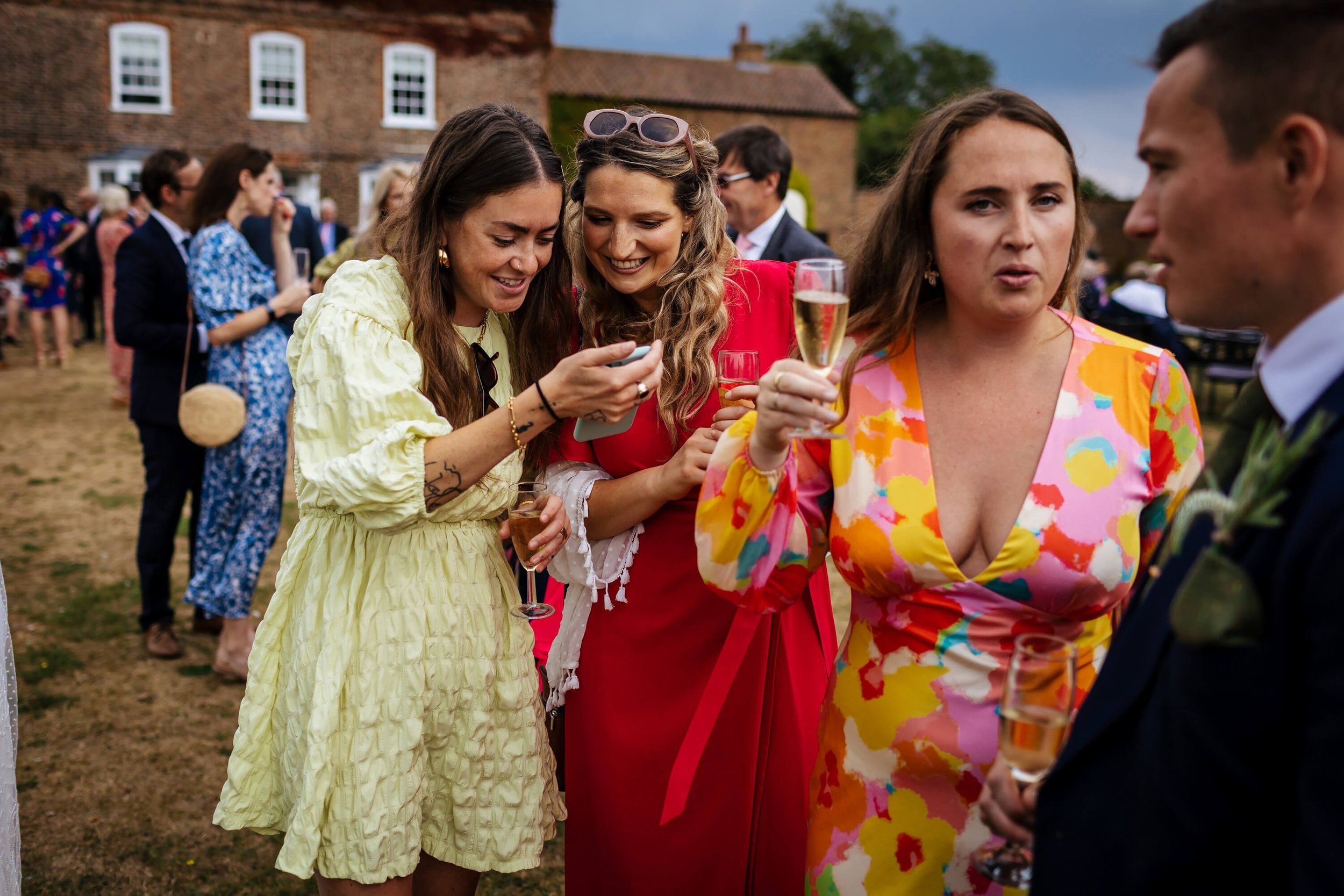 Wedding guests looking at their smartphone photos