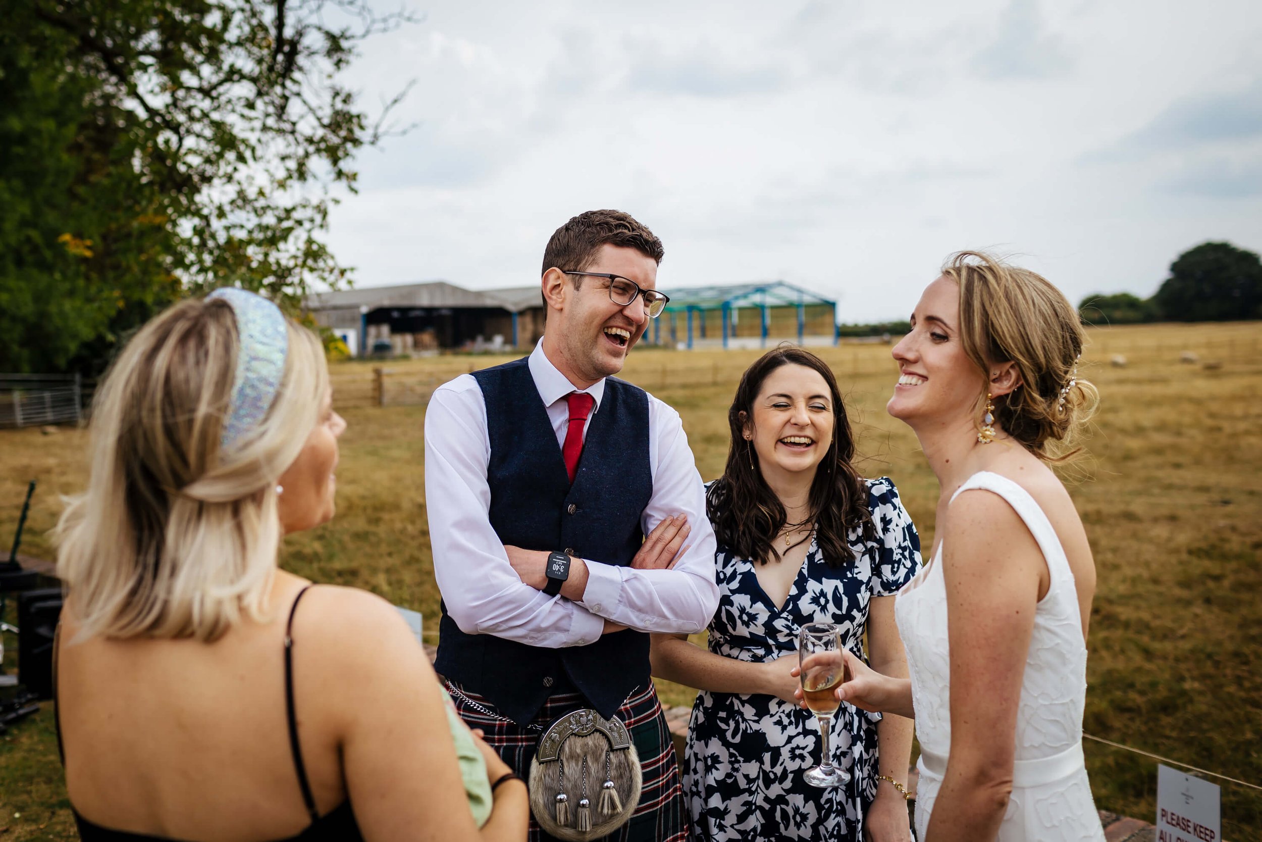 Wedding guests laughing with one another