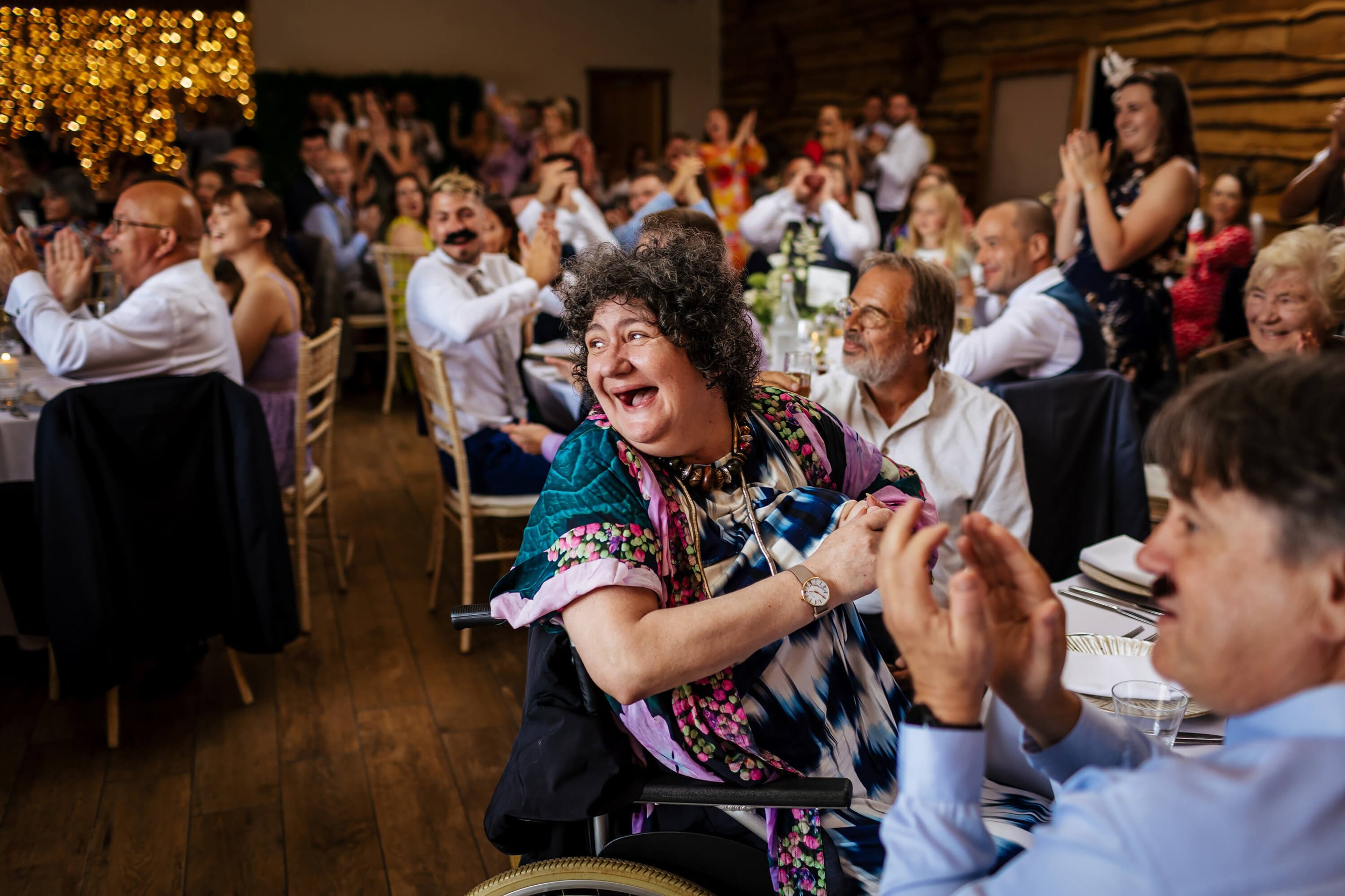 Wedding guests laughing during the reception