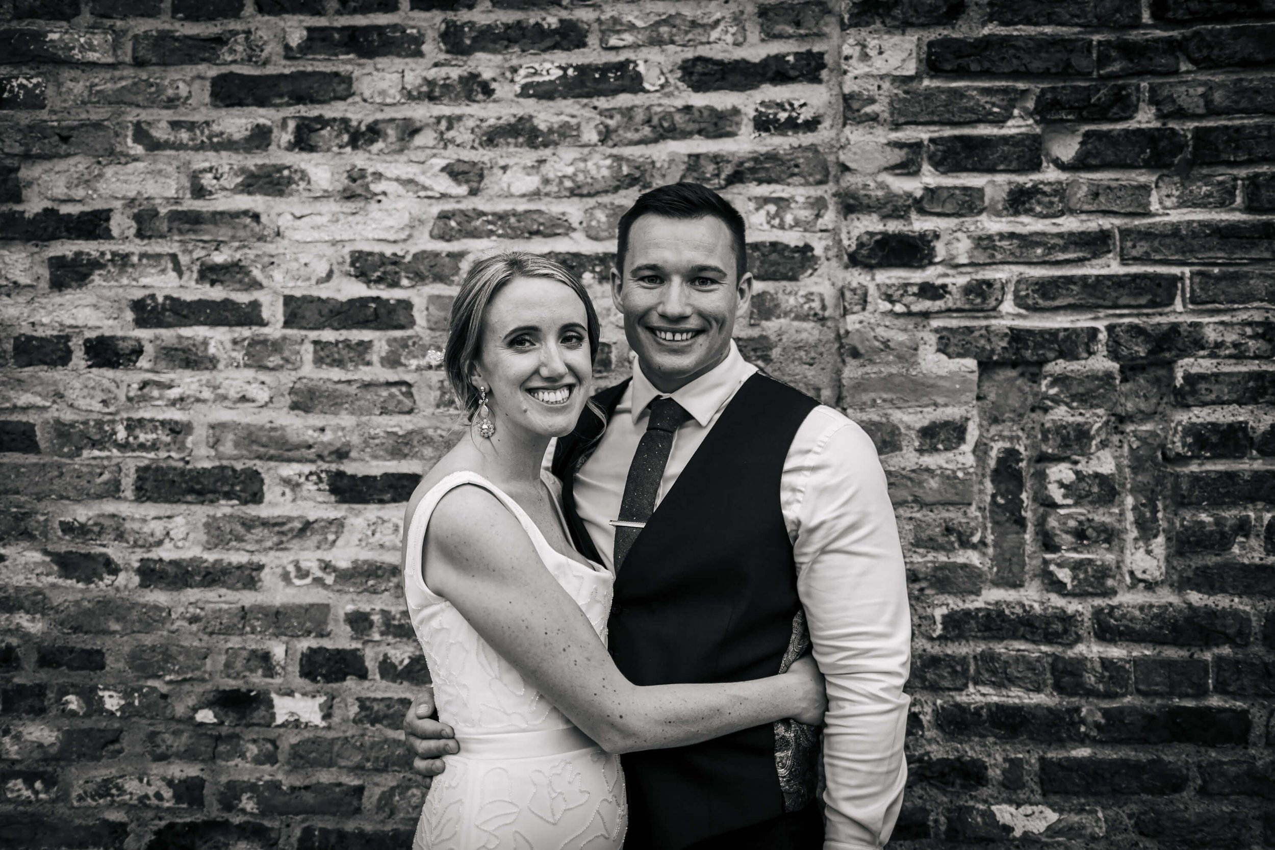 Posing for a photo with the bride and groom at their wedding