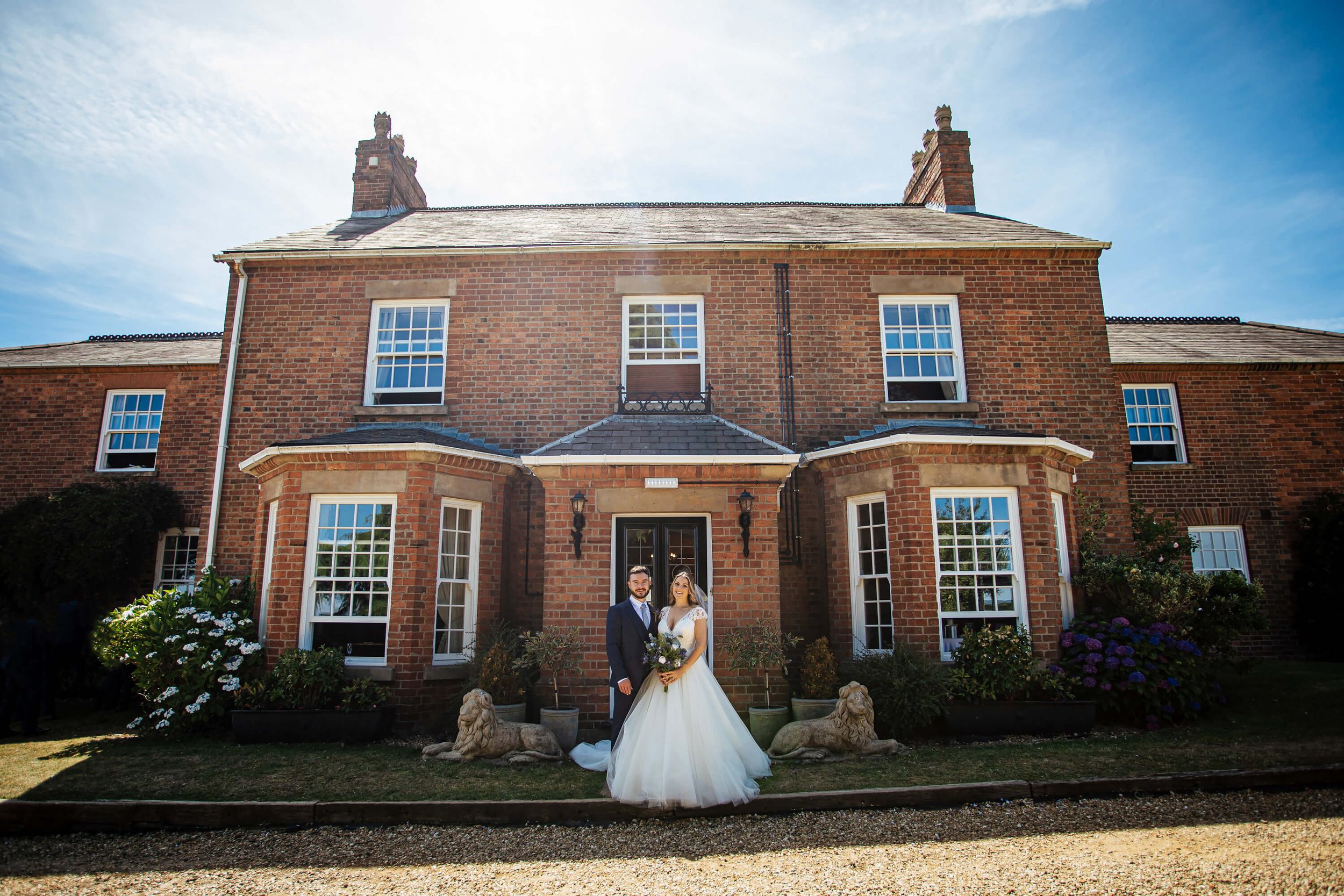 Bride and groom portrait in front of the farmhouse