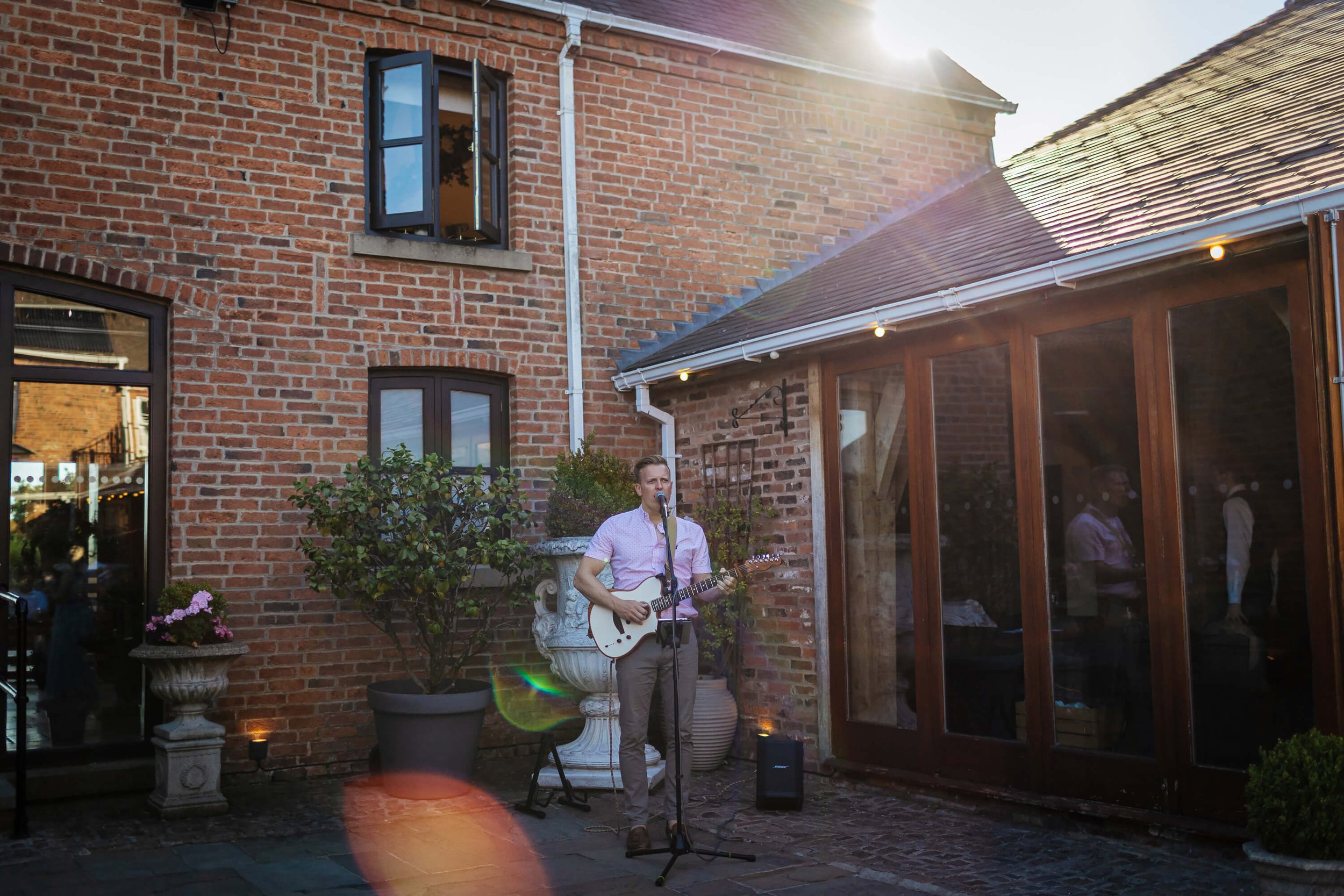 Guitarist in the sunshine at a wedding